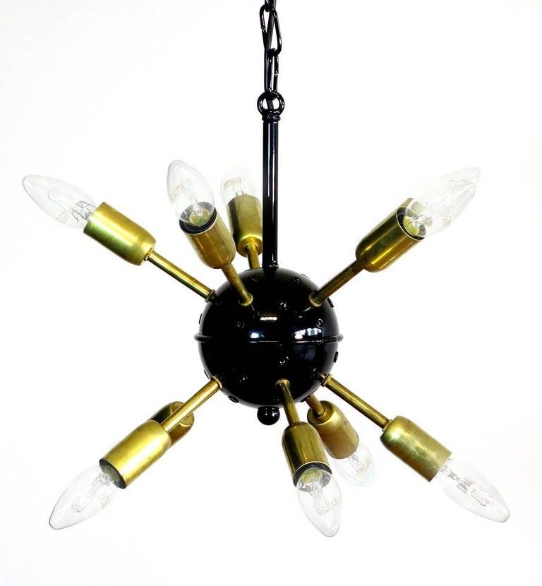 Sputnik chandelier surrounding 30 crystal glass 'triedri' prisms radiating from a centre black metal nucleus. Brass lamp holder.
Dimensions: 47.25 inches (120 cm) height with chain; 29.50 inches (75 cm) diameter.
Dimension glasses: 15 prisms