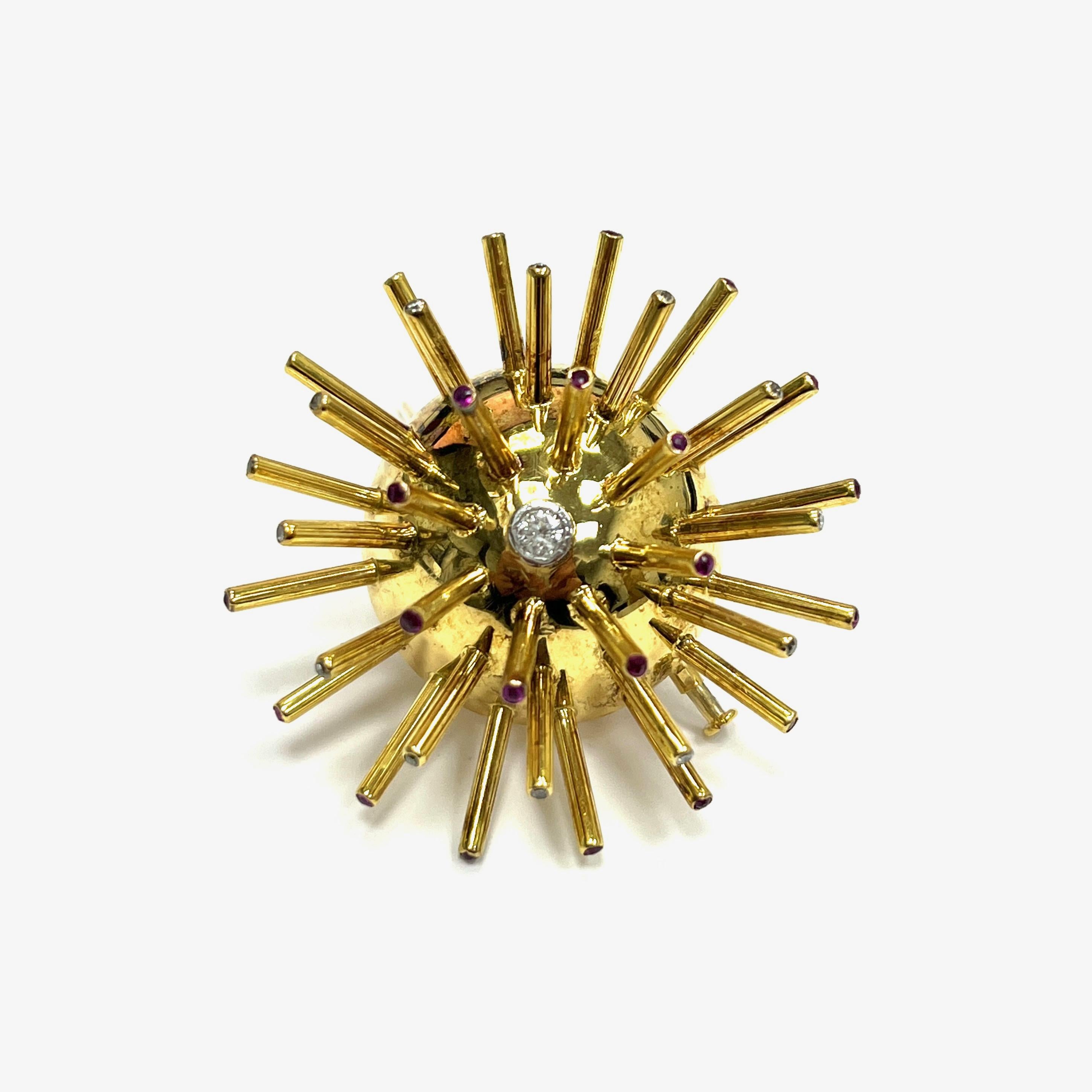 Sputnik diamond ruby yellow gold brooch

This brooch's design was inspired by Sputnik, the very first satellite that orbited the Earth. The end of each spike features a round-cut diamond or ruby, with a single main diamond at the ball's center. Made