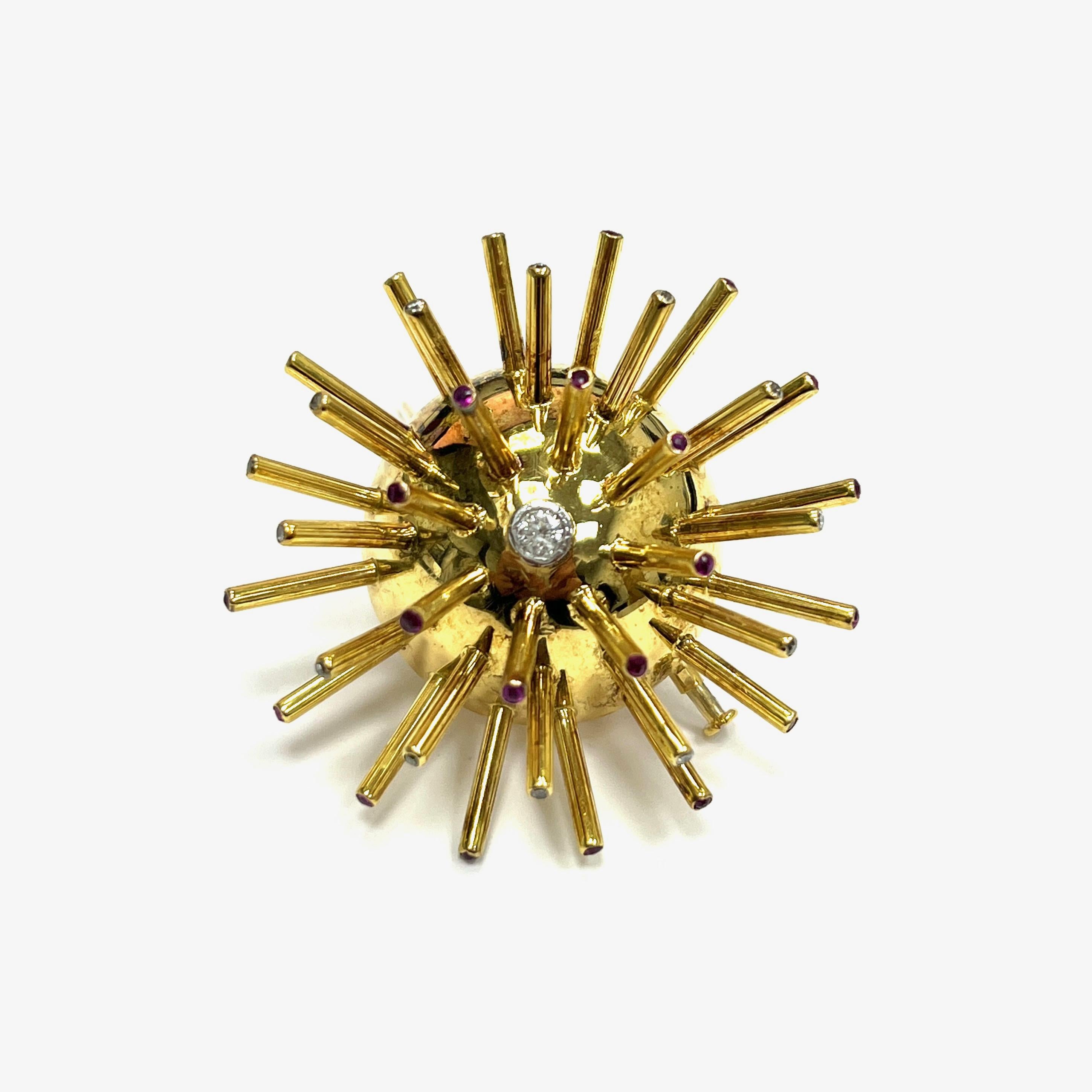Broche Sputnik diamante rubí oro amarillo

El diseño de este broche se inspira en el Sputnik, el primer satélite que orbitó la Tierra. El extremo de cada espiga presenta un diamante o rubí de talla redonda, con un único diamante principal en el