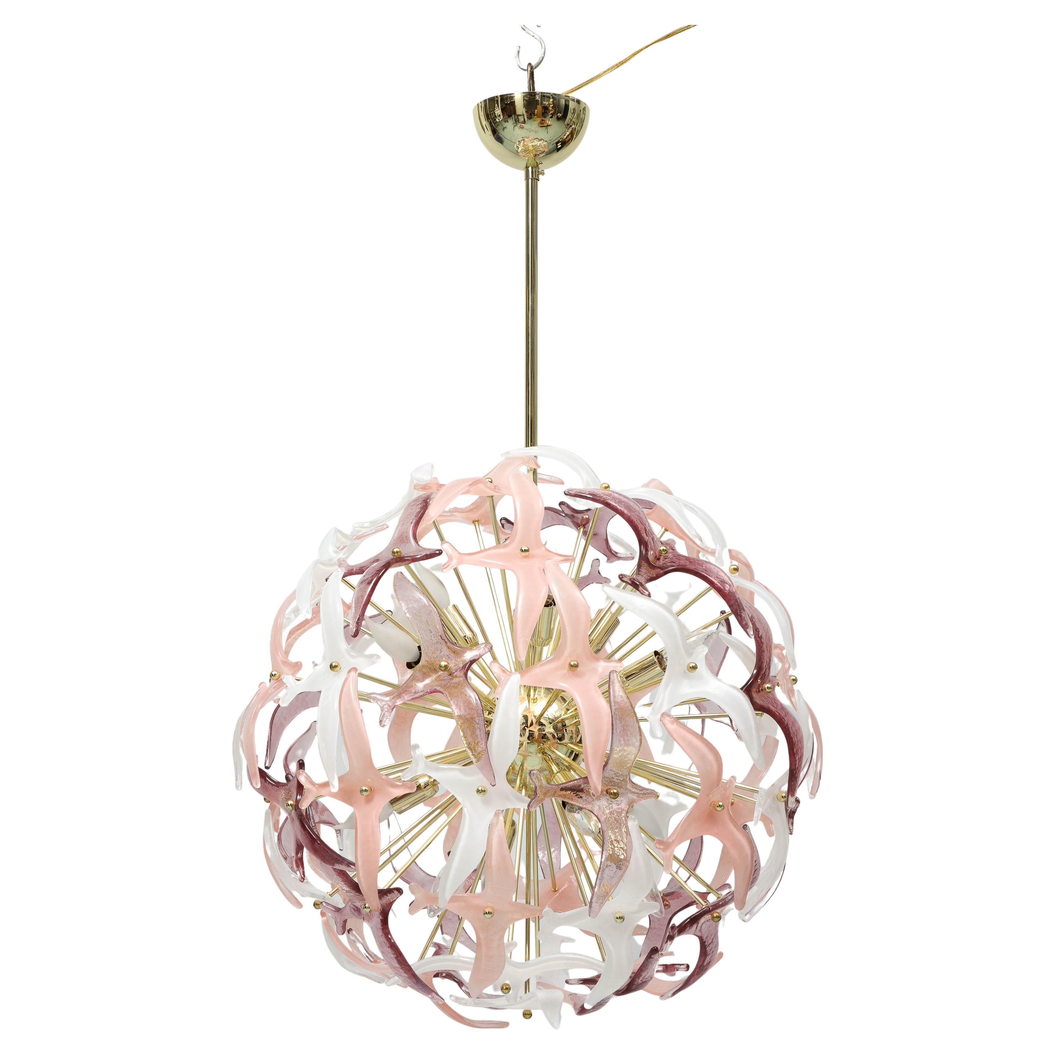 This sputnik chandelier made by an Italian artisan in his atelier is composed of Murano glasses which have shapes of wings. The white and pink wings also give the illusion of flowers.  The structure is in brass and of high quality. The chandelier is