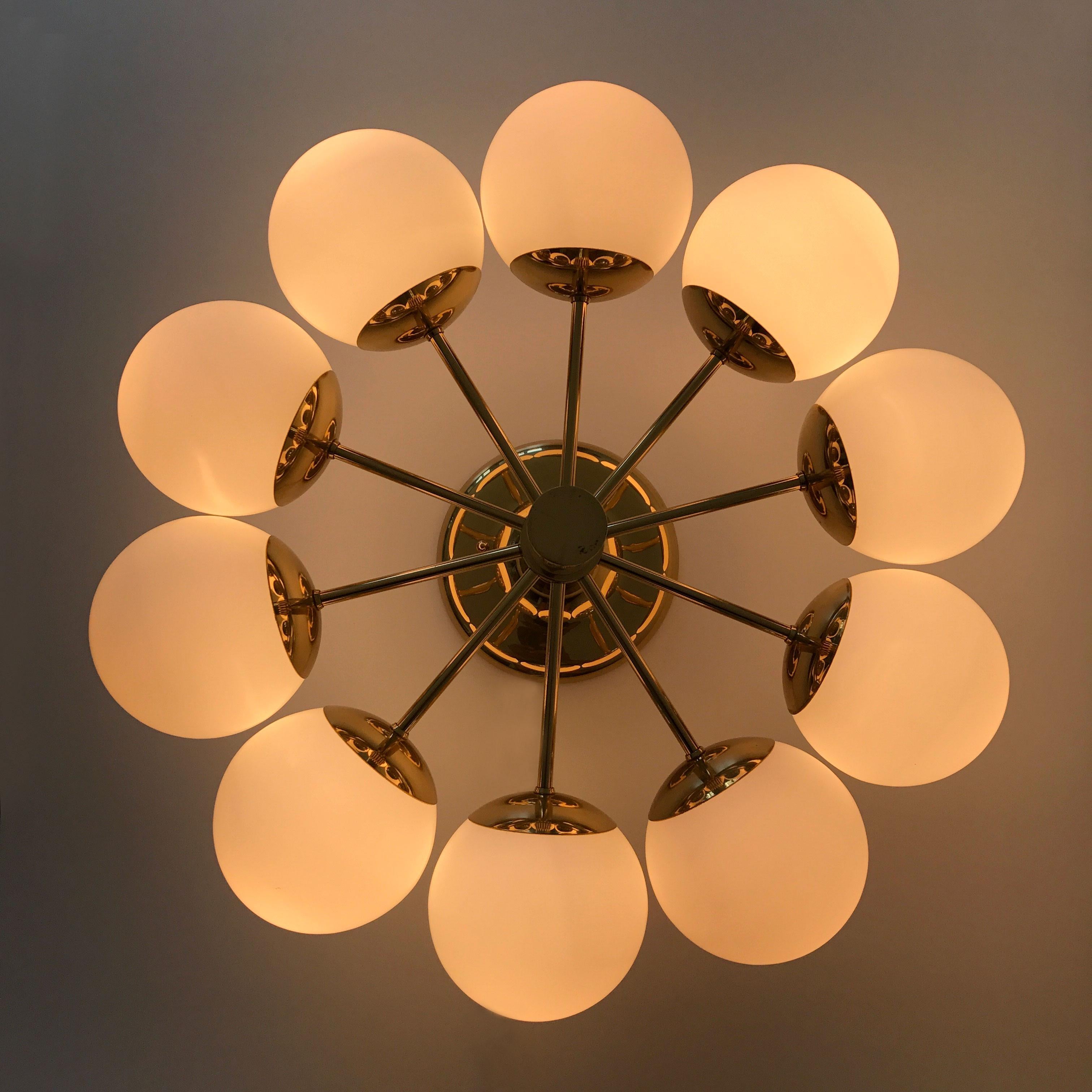 Spectacular ten-armed Mid-Century Modern Sputnik multi-globe chandelier or ceiling light by Kaiser Leuchten, Germany, 1970s.

Executed in polished brass, opaline glass. The chandelier or ceiling lamp needs 10 x E14 screw fit bulbs. Each max. 40