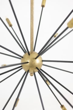 Sputnik-shaped chandelier in patinated gold-plated brass and black lacquer.