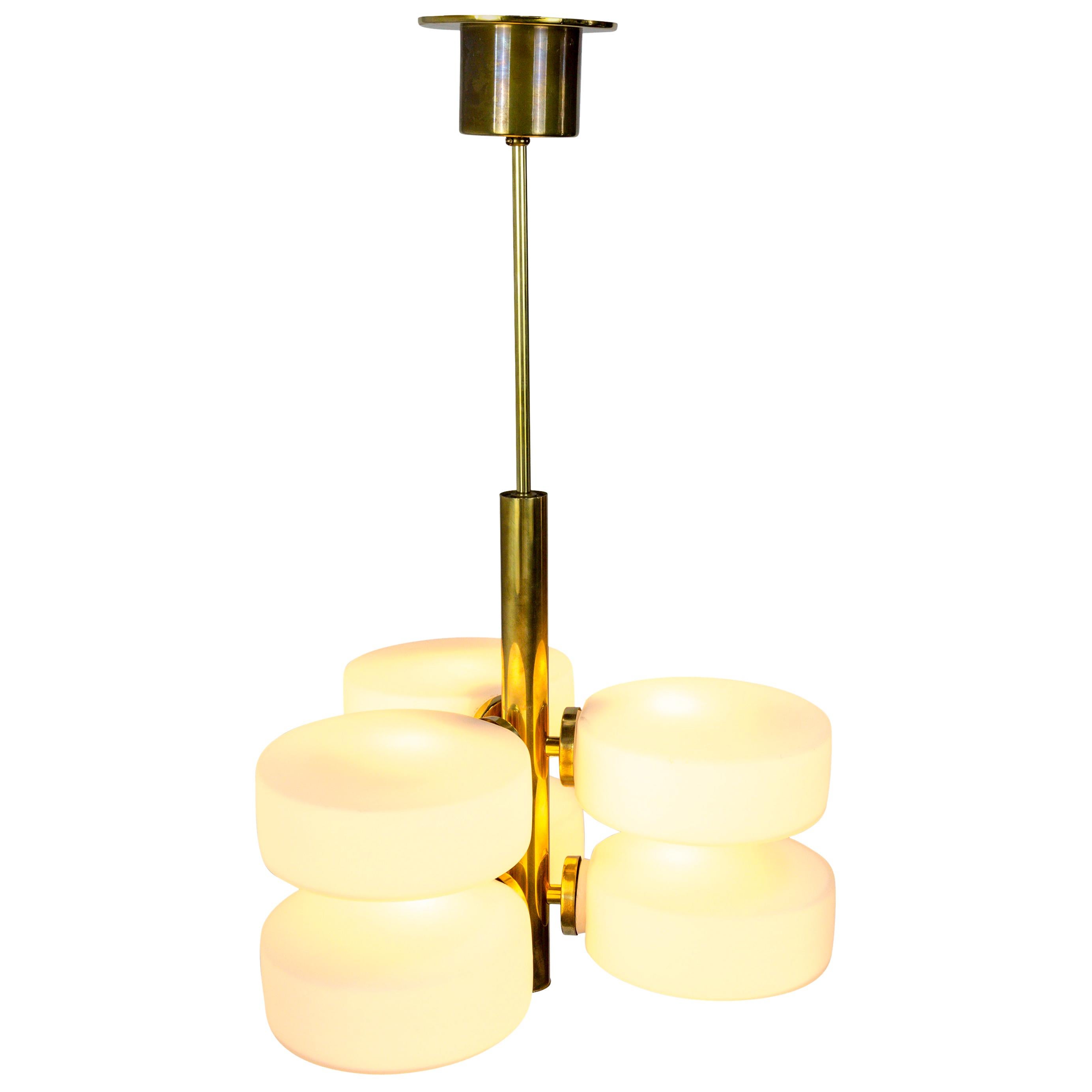 A rare Kaiser Leuchten sputnik pendant light with a sleek, polished brass stem and canopy, and six candelabra sockets with white, frosted glass disks, Germany, 1960s. Glass is easily pops on and off of socket for quick bulb replacement. Measures: