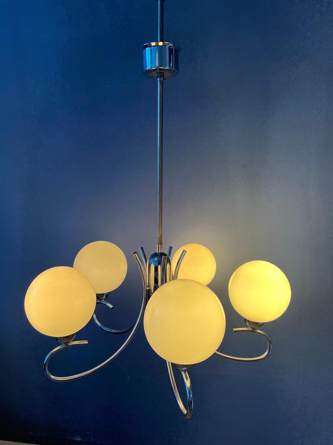Mid century sputnik space age glass chandelier. The light fixture has a chrome frame and five opaline glass shades. The lamp requires five E14 lightbulbs.

Additional information:
Materials: Glass, metal
Period: 1970s
Dimensions:ø Chandelier: 65