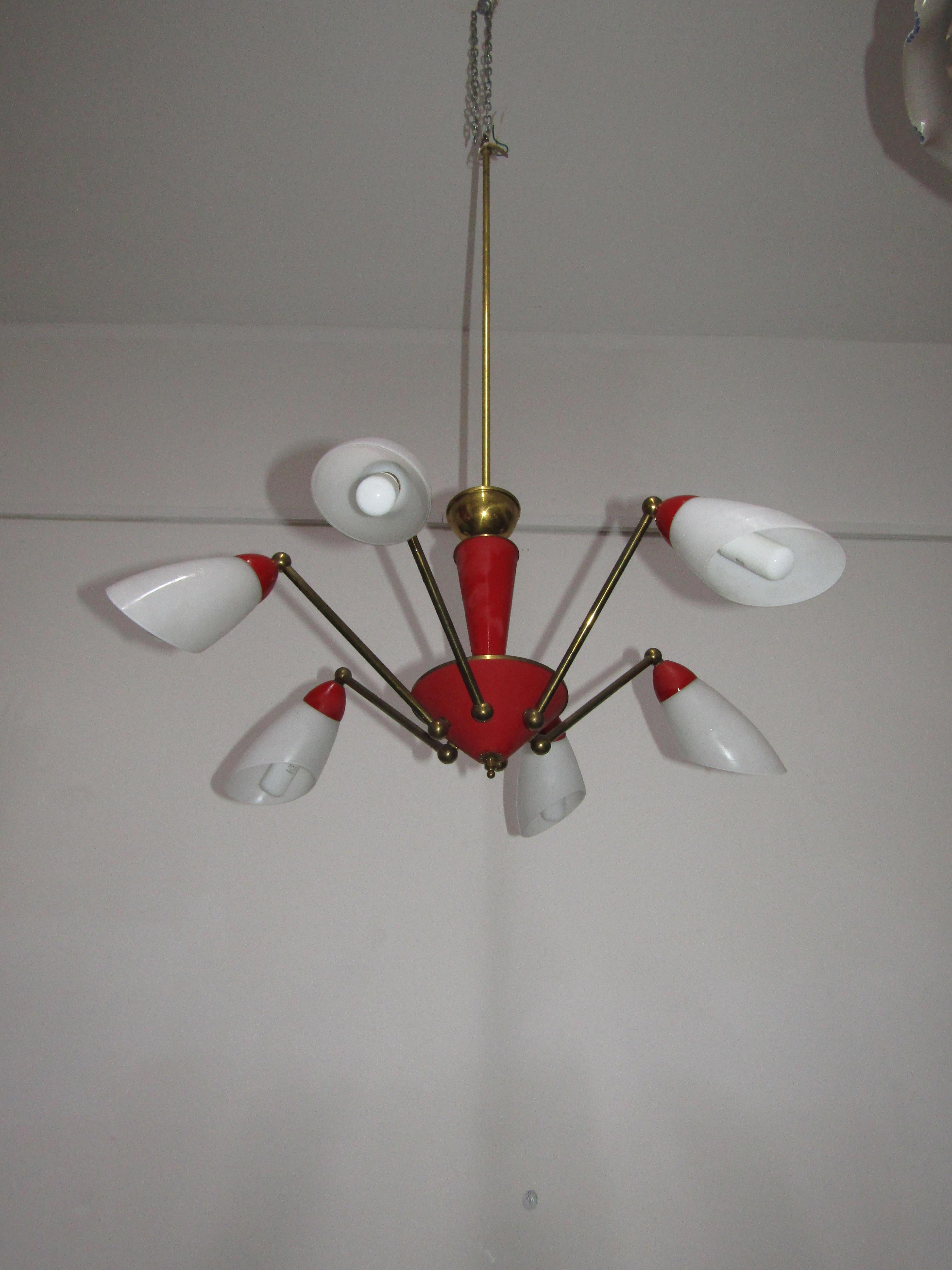 Sputnik Stilnovo chandelier with six arms and opal glass lampshades. The structure is in brass and parts in red painted aluminum.