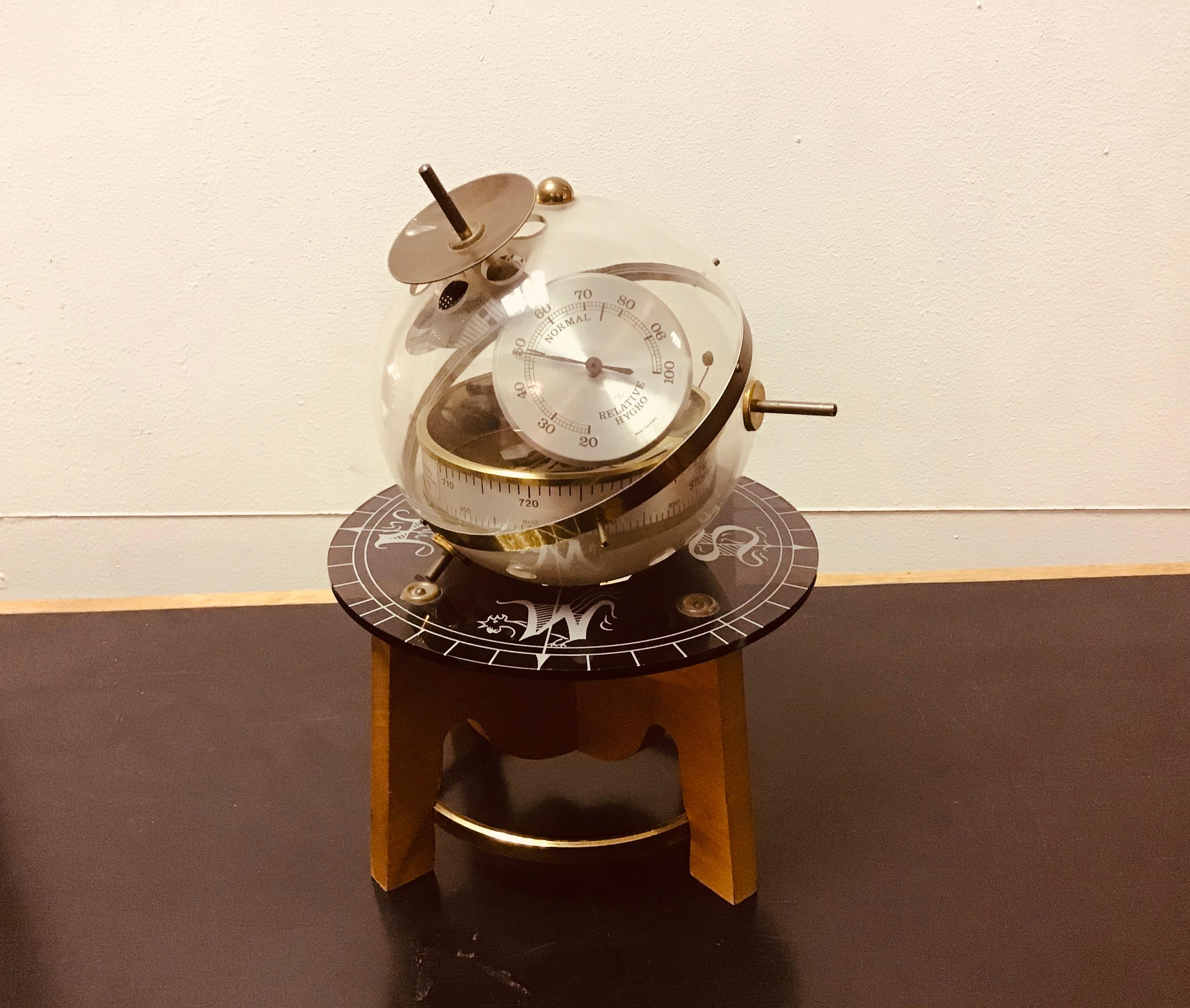 Fantastic object Sputnik table Barometer, Hygrometer and thermometer
Made with acrylic sphere that rotate on it axis with a wooden and brass base,
 circa 1950s, German.