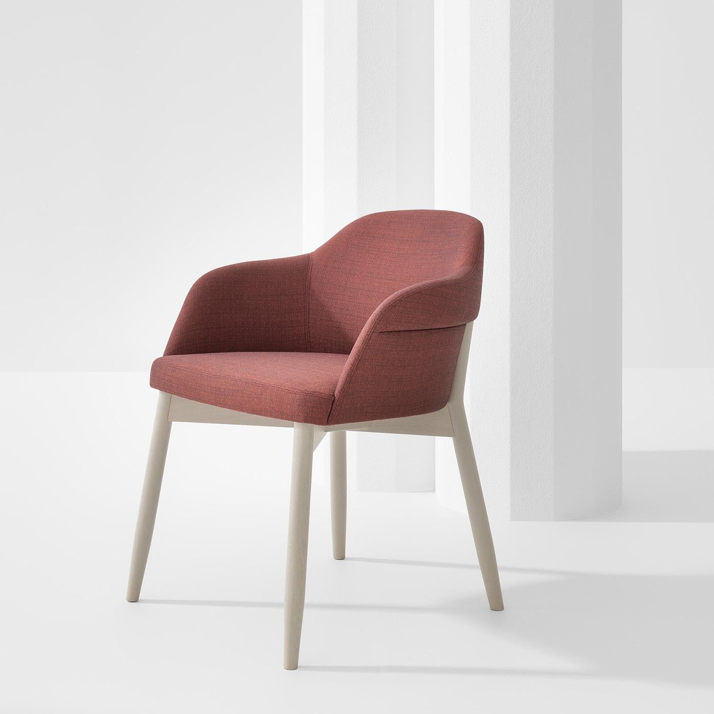 This outstanding lounge chair by Emilio Nanni plays with colors and smooth lines, resulting in a perfect balance of rare sophistication. Crafted of solid beech tinted in silk gray, the silhouette includes four fluted legs supporting the wide seat