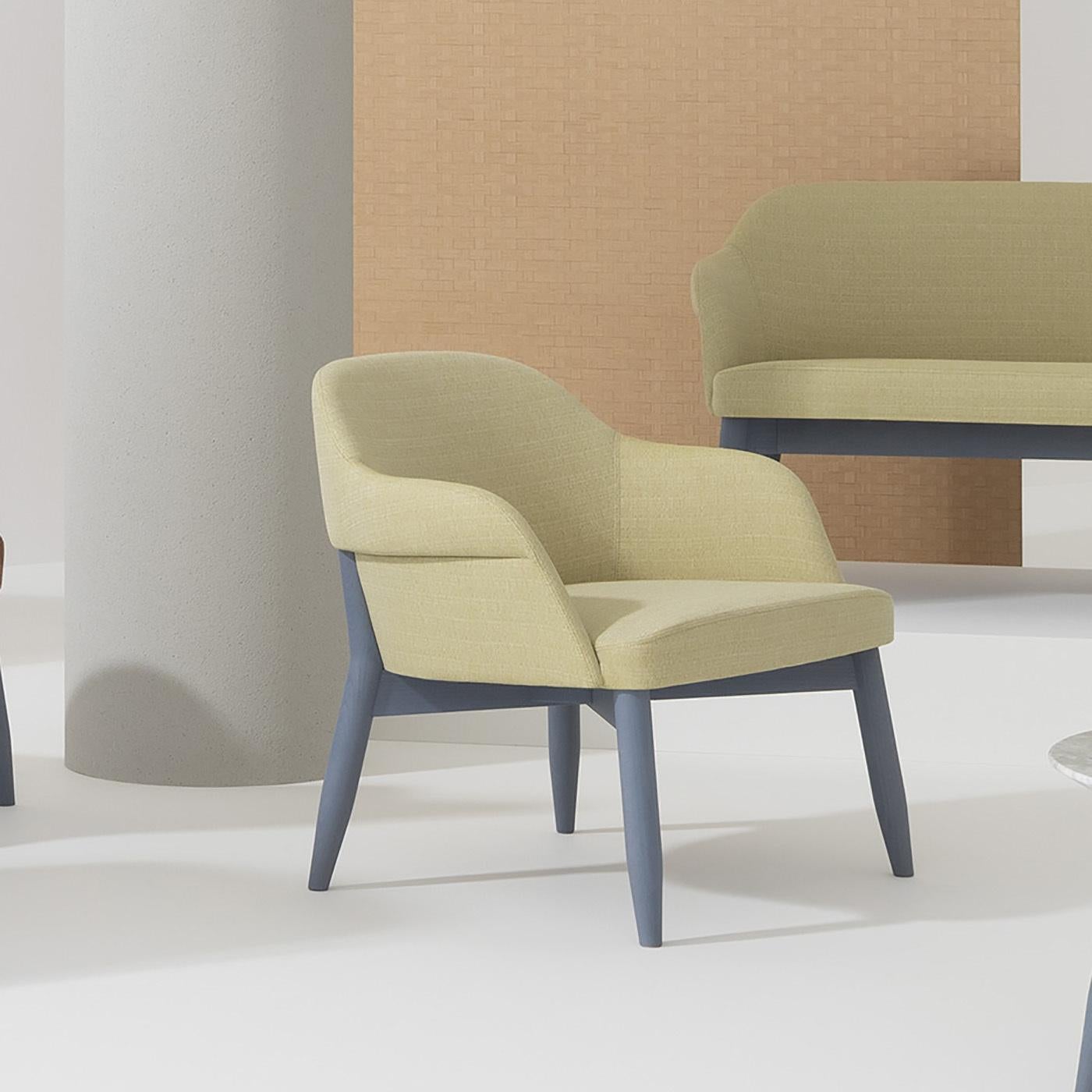 This sophisticated armchair is the perfect accent piece to bring a pop of color to modern decors with its well-balanced aesthetic. The frame in solid beech includes four tapered legs tinted in pigeon-blue sustaining the welcoming seat (height 41 cm)