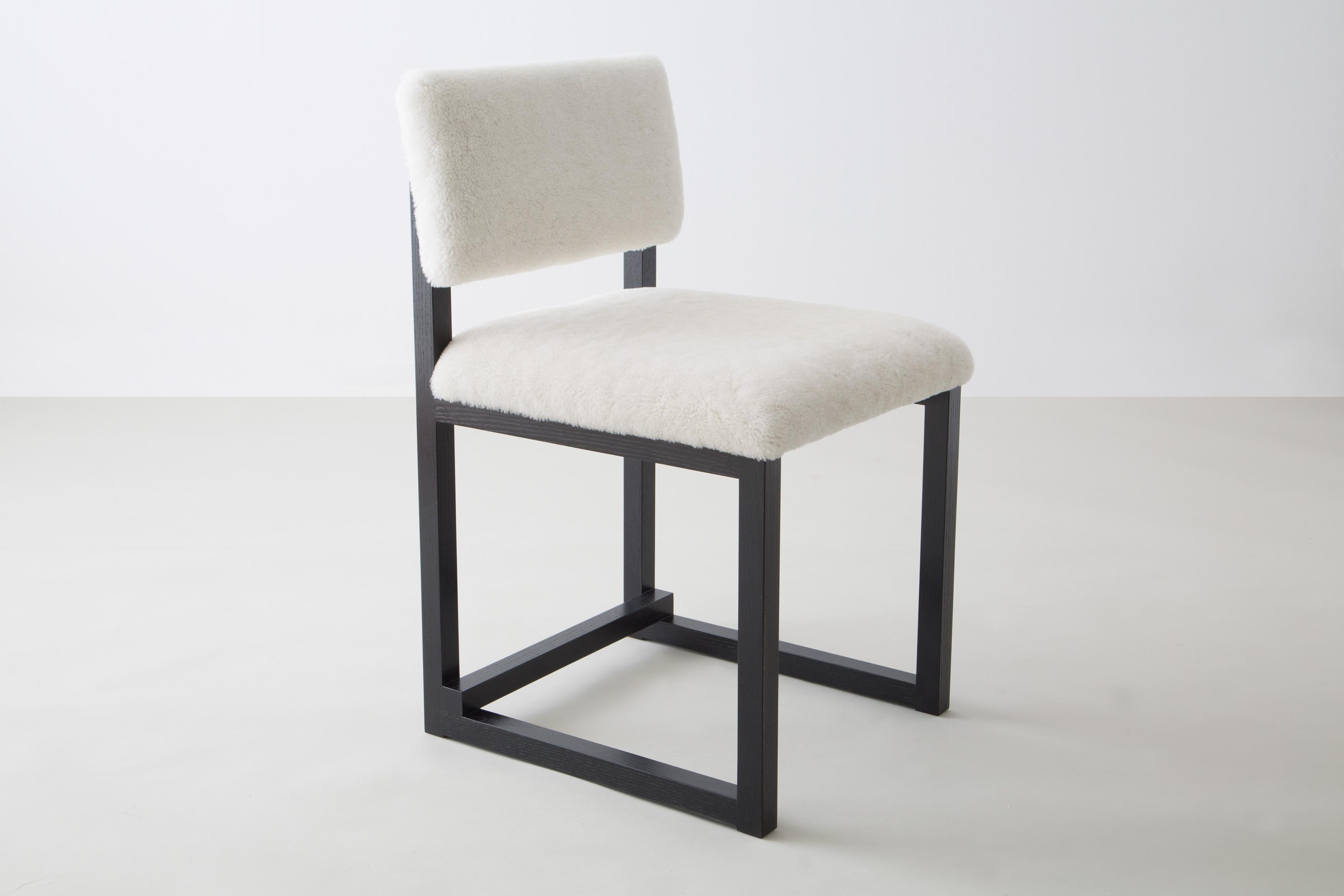 Shown in ebonized ash and white washed ash, cream shearling, and brass hardware
 
Also available:
Wood in solid ash, cherry, maple, walnut, or white oak

Upholstery in customer’s own material or leather (COM+COL) 

Metal in brushed brass, antique