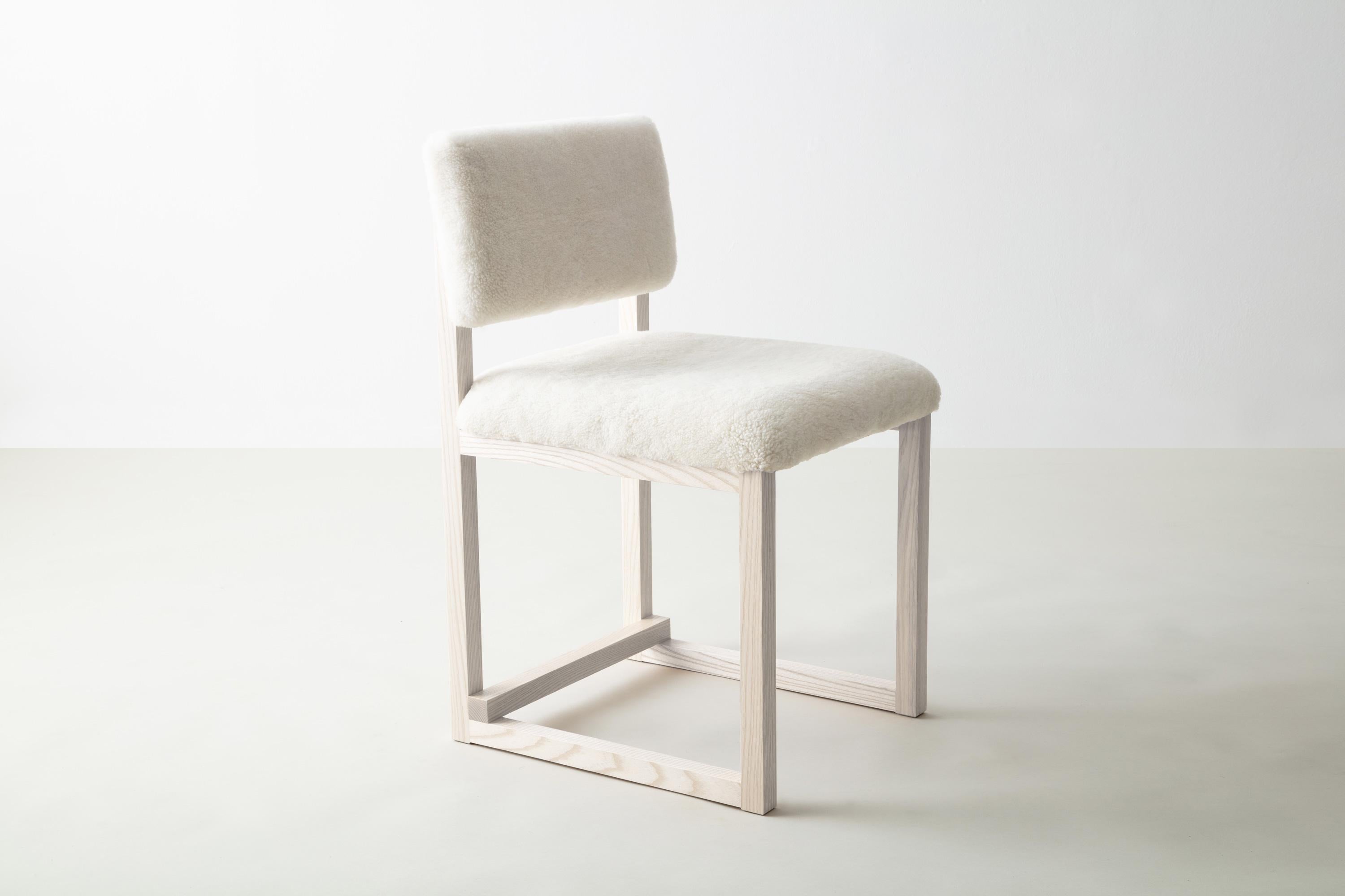 Shown in white washed ash and ebonized ash, cream shearling, and and brass hardware
 
Also available:
Wood in solid ash, cherry, maple, walnut, or white oak

Upholstery in customer’s own material or leather (COM+COL) 

Metal in brushed brass,