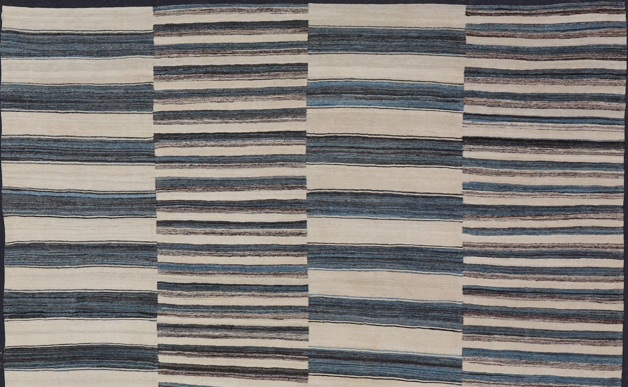 Modern flat-weave Kilim rug with stripes in shades of light blue, charcoal, blue, cream. Rug AFG-60, Keivan Woven Arts / country of origin / type: Afghanistan / Kilim

This flat-woven Kilim rug features a Classic stripe design that places