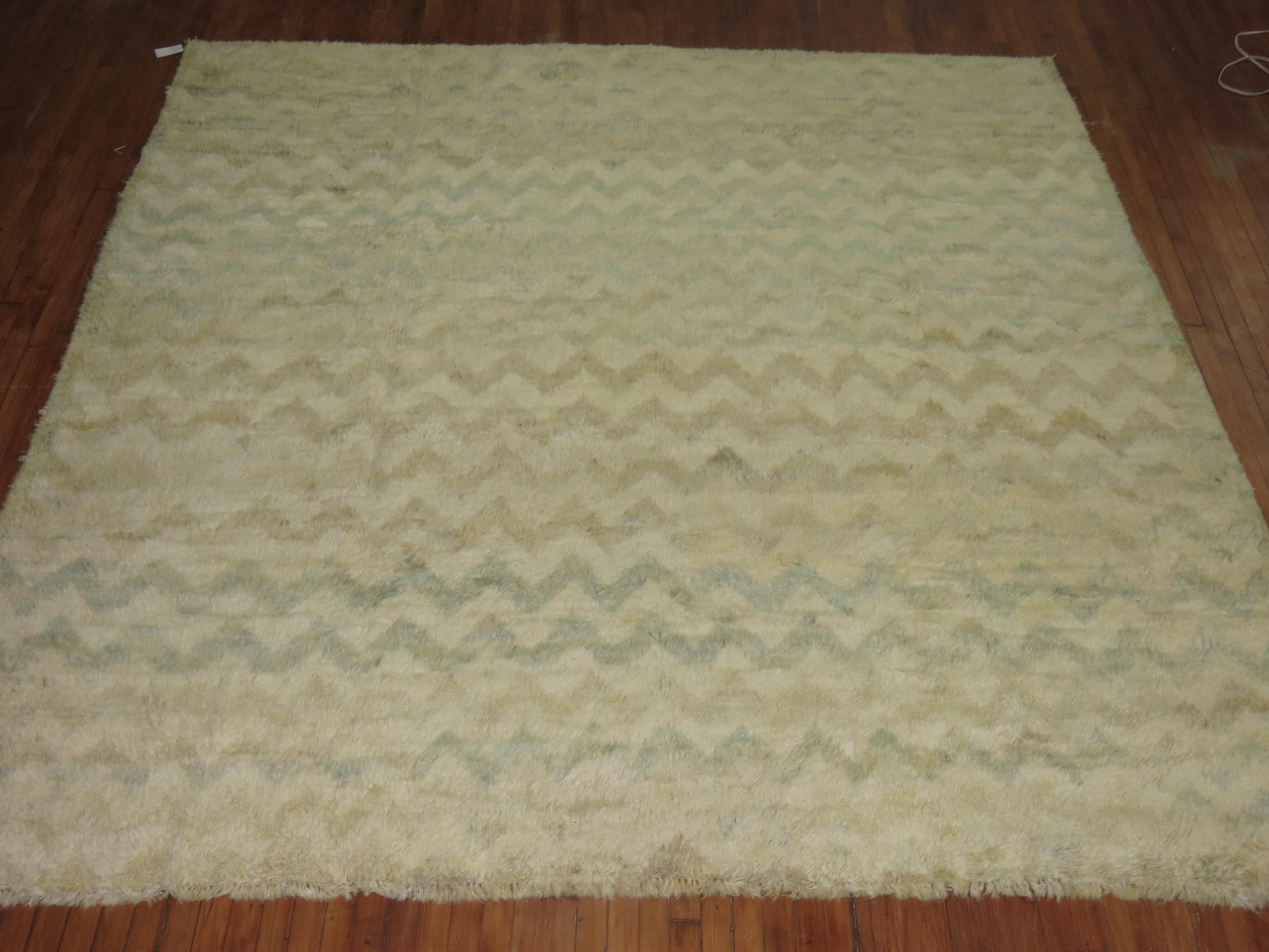 Modern Persian square rug with an all-over chevron motif in ivory and pale green blues. Made with recycled wool derived from 20th century Turkish rugs.
Measures: 9'7'' x 10'3''.