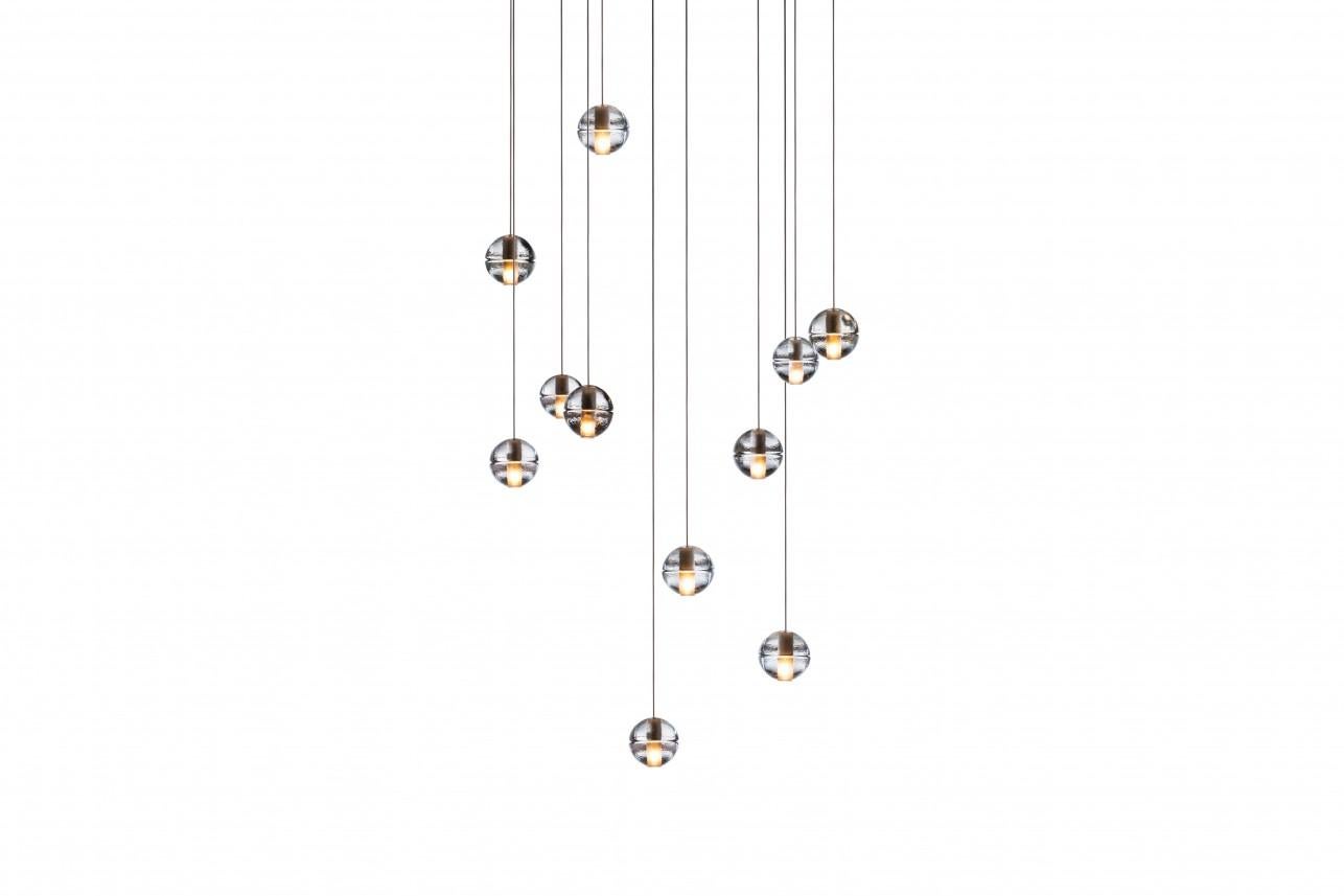 Square 14.11 chandelier lamp by Bocci
Dimensions: D 50.8 x W 50.8 x H 300 cm 
Materials: Brushed nickel, cast glass, blown borosilicate glass, braided metal coaxial cable, electrical components, white powder-coated canopy.
Available in