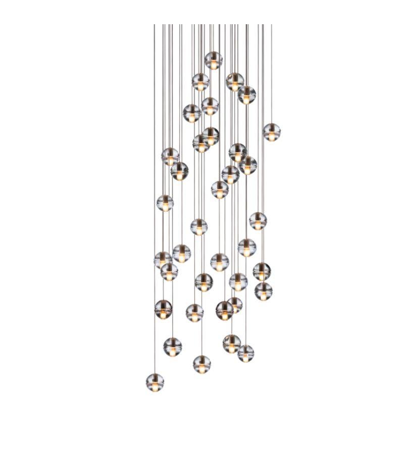 Square 14.36 chandelier lamp by Bocci
Dimensions: D 75.5 x W 75.5 x H 300 cm 
Materials: Brushed Nickel, Cast glass, blown borosilicate glass, braided metal coaxial cable, electrical components, white powder-coated canopy.
Available in Round, or