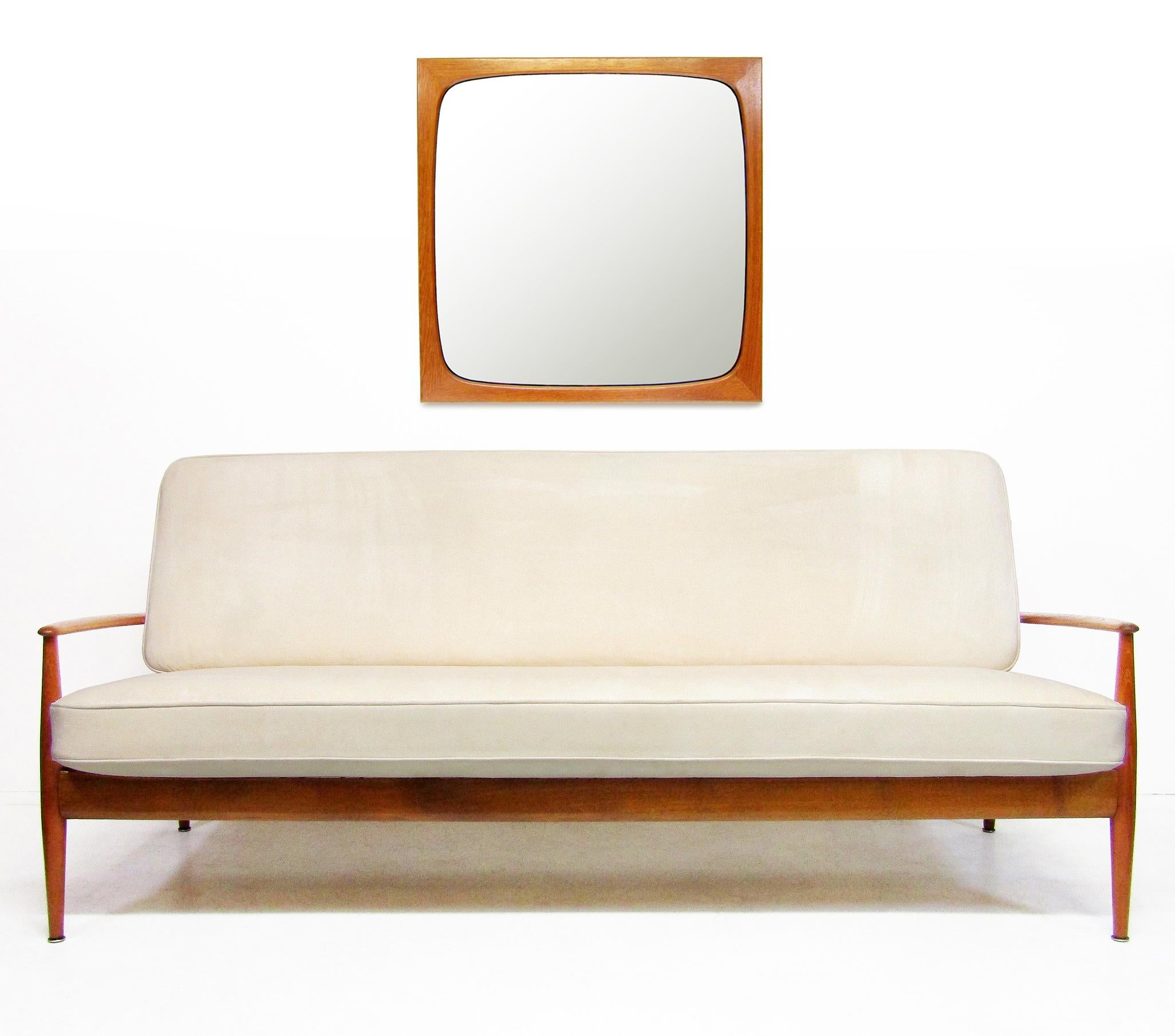 A sleek 1960s mirror in teak by Danish maker Aksel Kjersgaard.

The sculpted contours of this mirror show quality typical of the maker and the period. 

It is in excellent, clean condition, with barely any signs of age. It would suit any modern