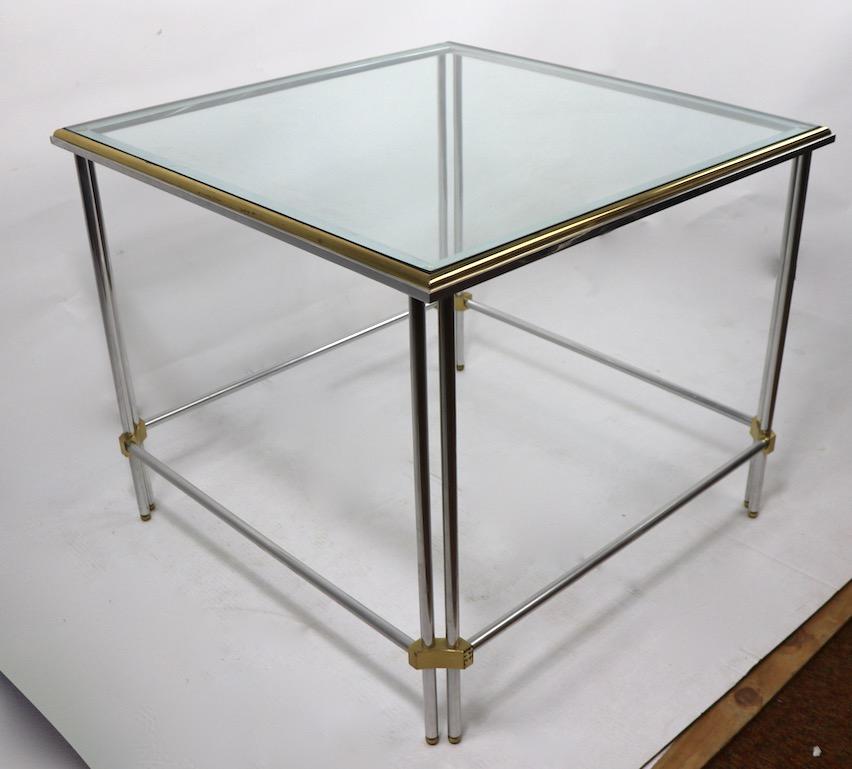 Elegant and sophisticated square end or side table by John Vesey. The table has brass ball feet, tubular aluminum column legs with brass joinery, which support the plate glass top. Very fine, original condition, showing only very minor cosmetic