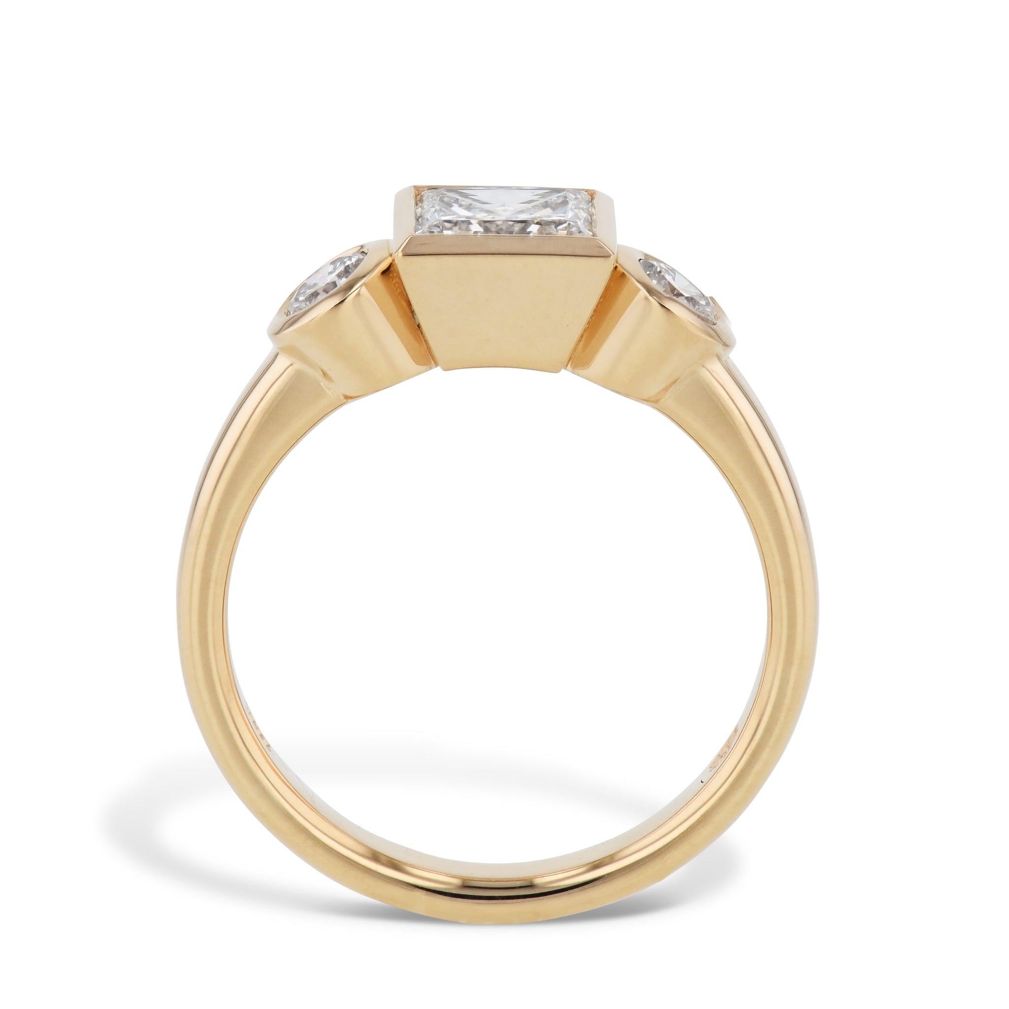 Our Square & Round Bezel Set Diamond Engagement Ring exudes glamour and personality. With a magnificent square center stone, two round side diamonds, and 18kt yellow gold. This glamorous ring will be treasured for generations. Handmade with