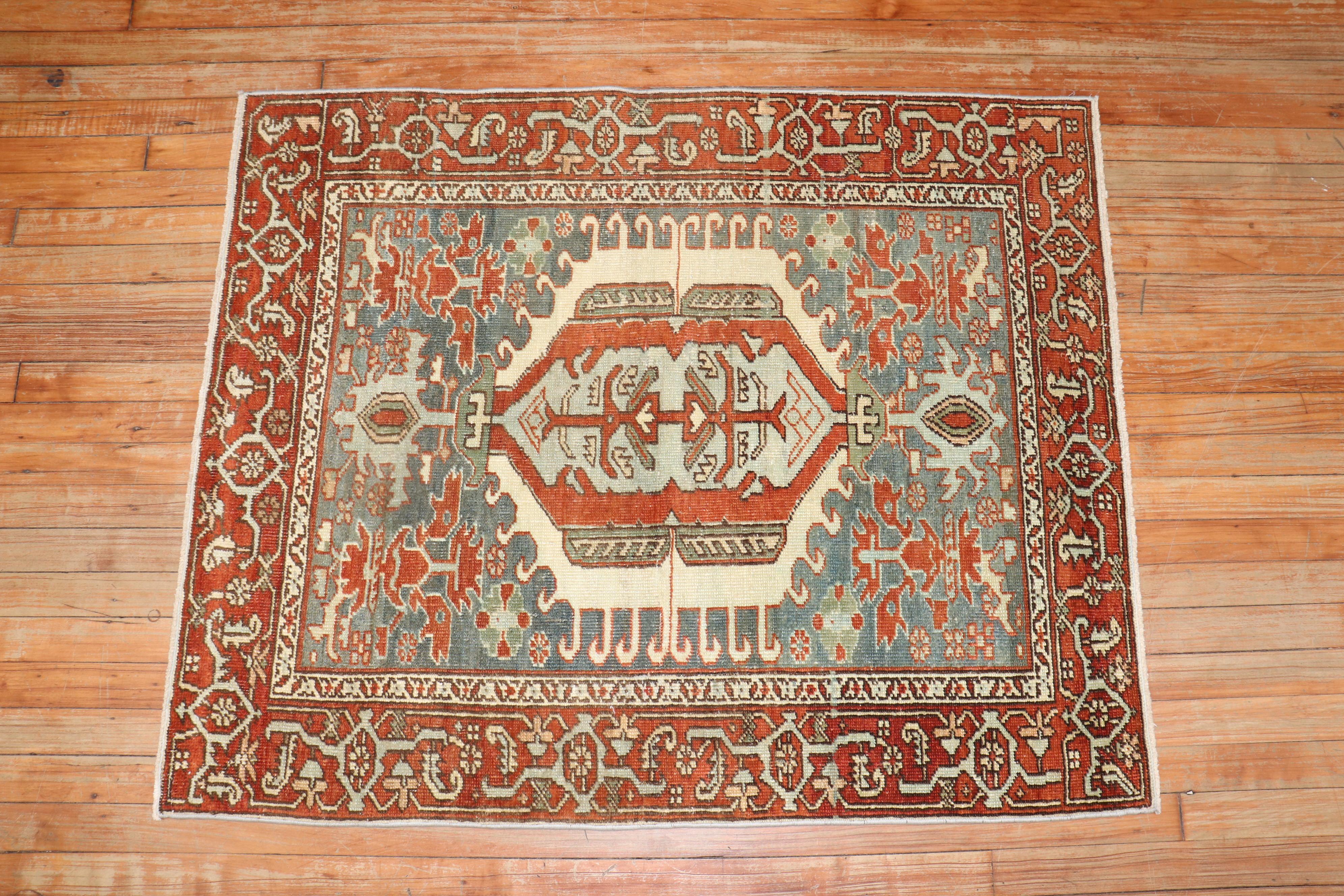 A Square Antique Persian Heriz rug from the 2nd quarter of the 20th century.

Measures: 3'4'' x 4'1''.