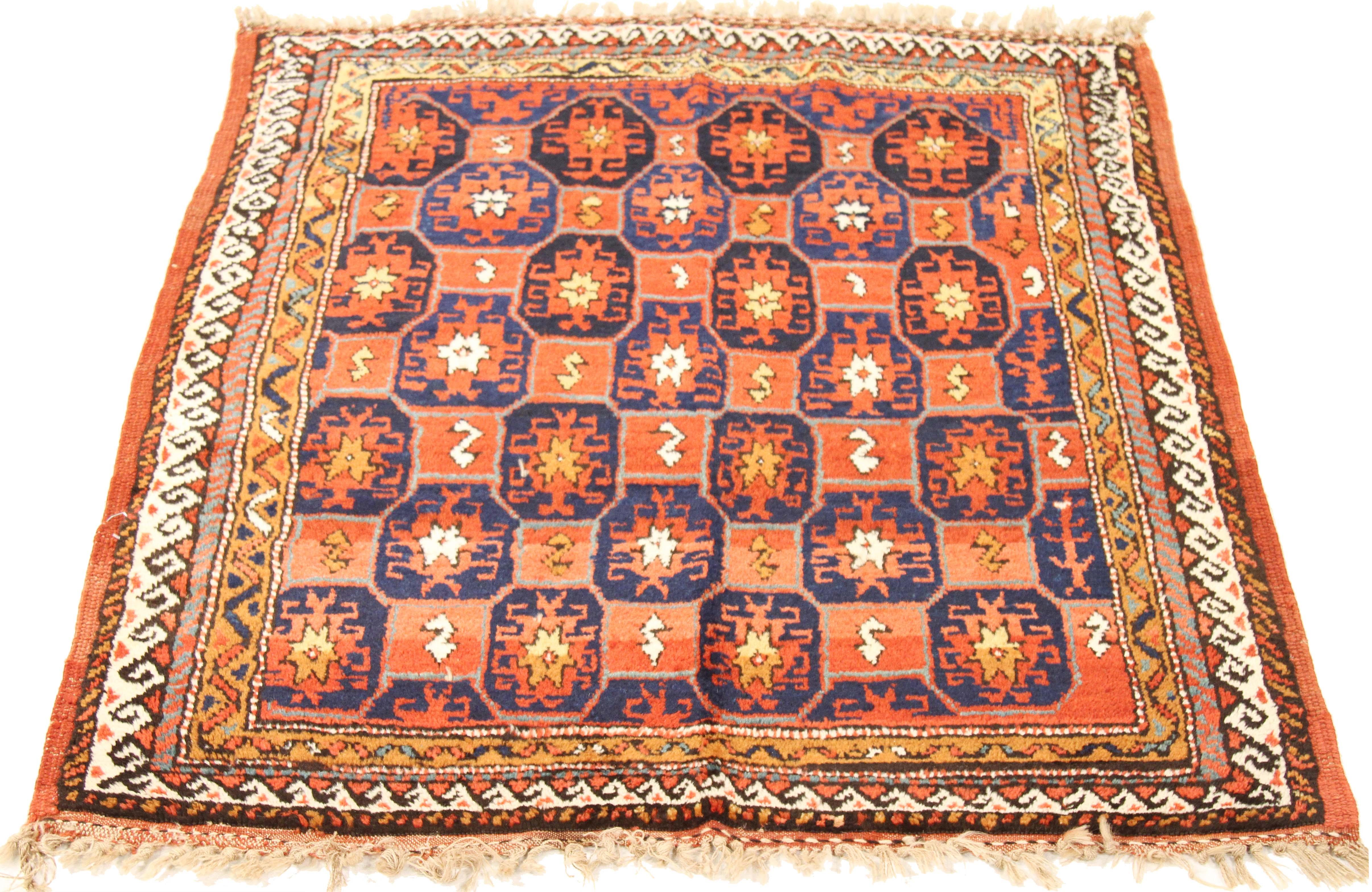 Antique Persian rug handwoven from the finest sheep’s wool and colored with all-natural vegetable dyes that are safe for humans and pets. It’s a traditional Kurdish design highlighted by large and small geometric medallions in navy and red. It’s a