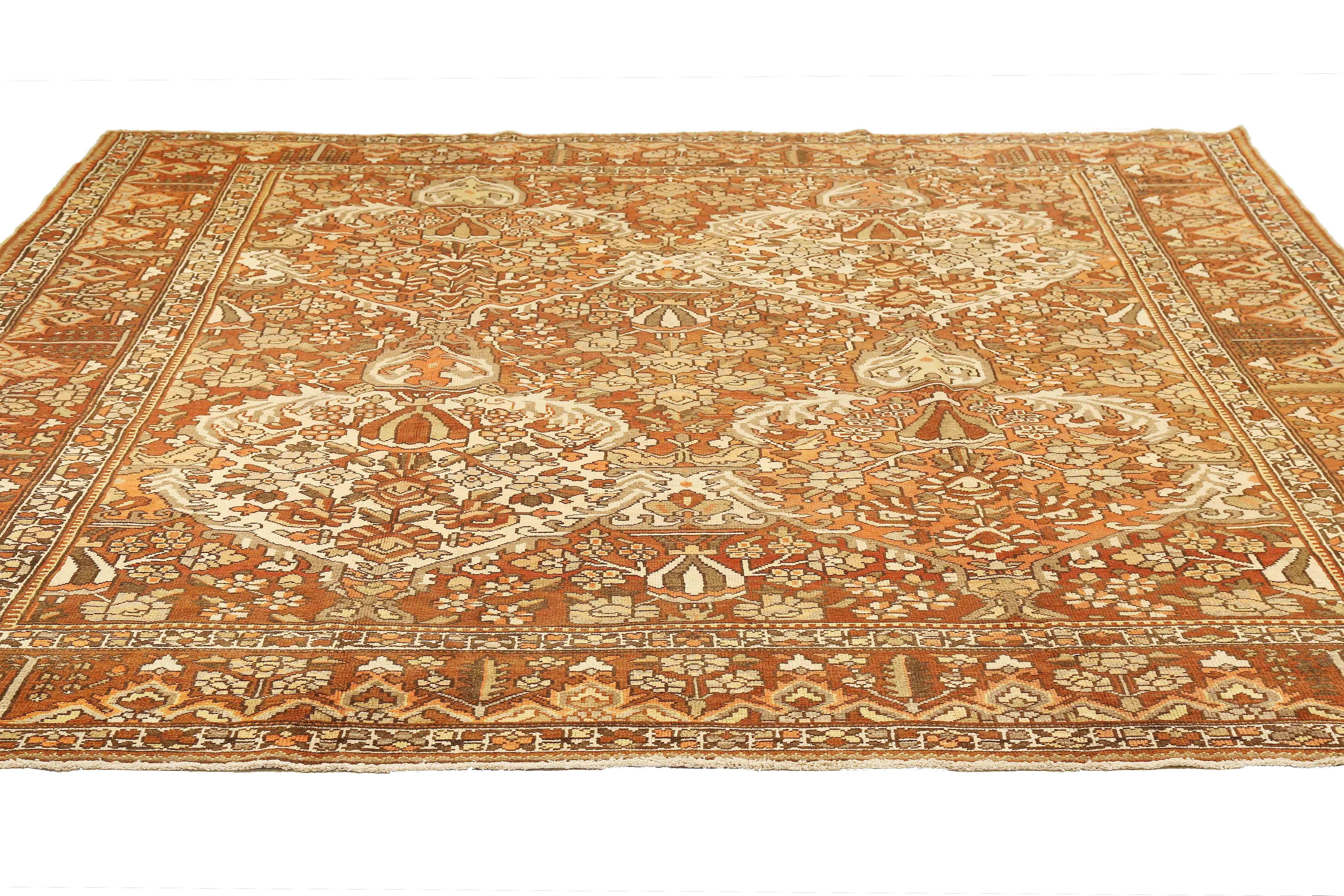 Antique Persian rug handwoven from the finest sheep’s wool and colored with all-natural vegetable dyes that are safe for humans and pets. It’s a traditional Bakhtiar design highlighted by brown and white botanical details over a beige field. It’s a