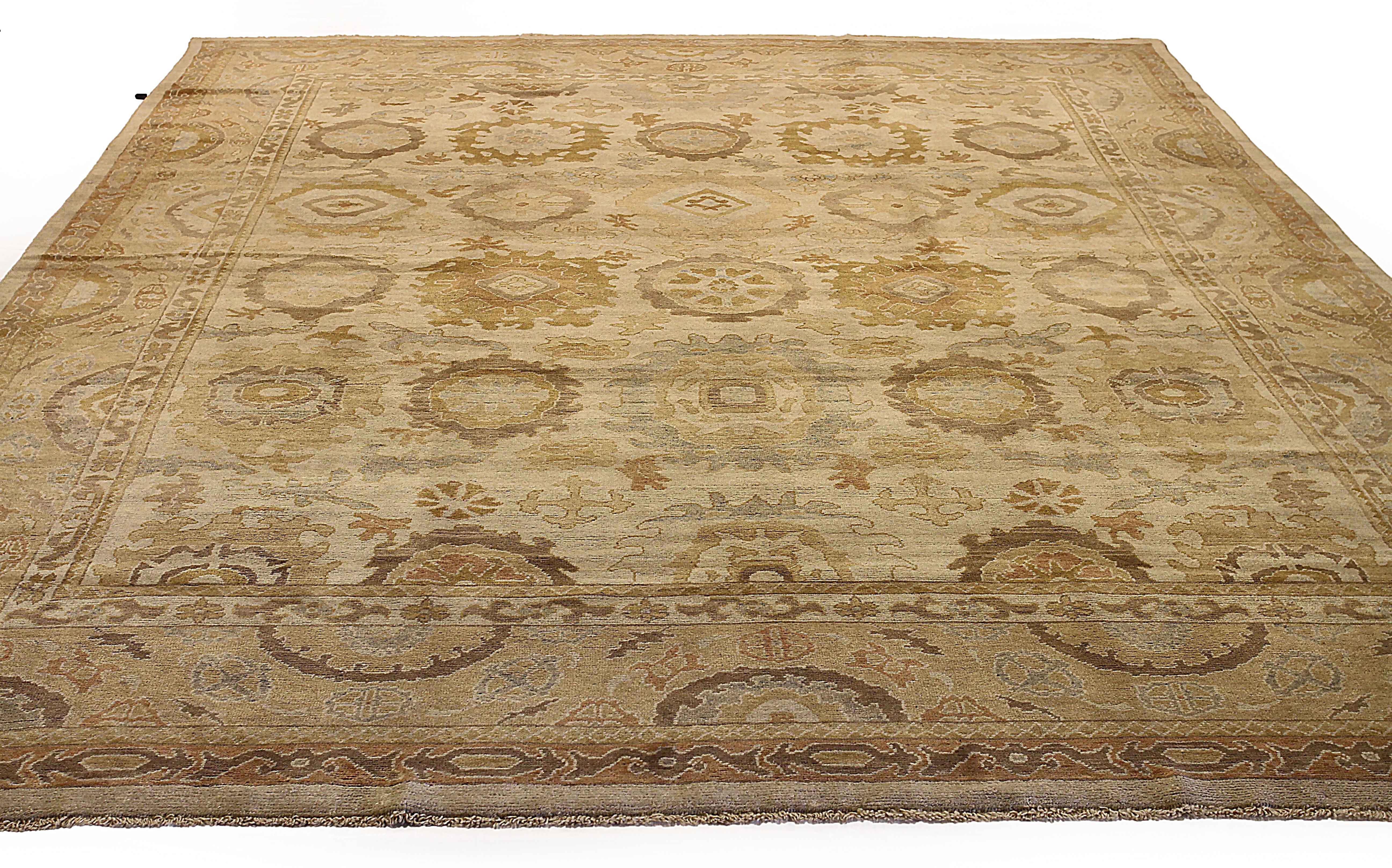 Antique handmade Turkish area rug from high quality sheep’s wool and colored with eco-friendly vegetable dyes that are proven safe for humans and pets alike. It’s a classic Oushak design showcasing a regal brown and blue  field with prominent Herati