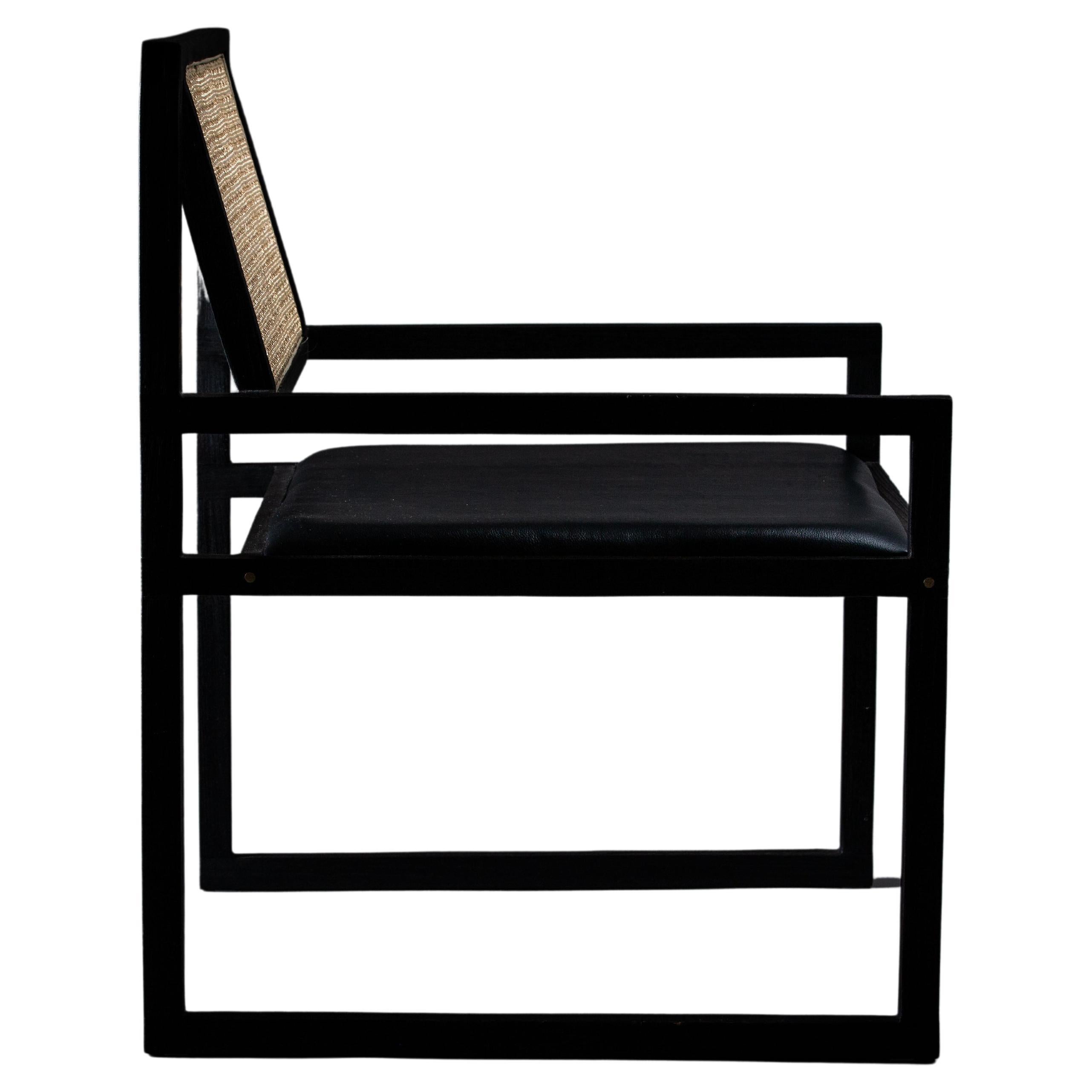 Charred using the Japanese technique shou sugi ban, it's a light and airy piece with straight lines and angles. Crafted from Freijó wood, it's exceptionally comfortable and durable, featuring a foam-padded seat upholstered in genuine leather and a