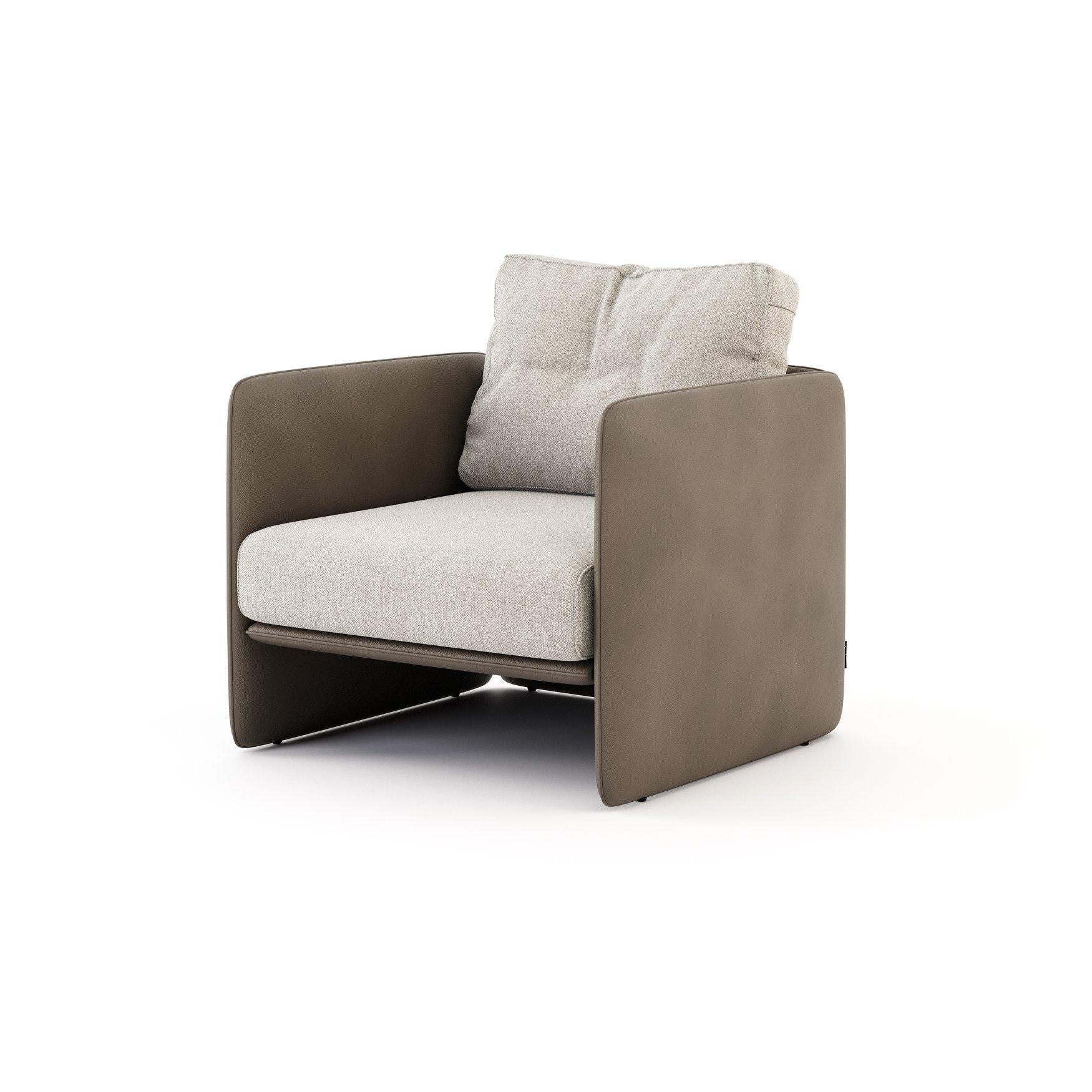 This is a one-of-a-kind armchair that perfectly matches the square shapes of its structure with the soft curves and comfort of the upholstery. The padded structure is upholstered in a different fabric as the seat and back pillows. You can mix and