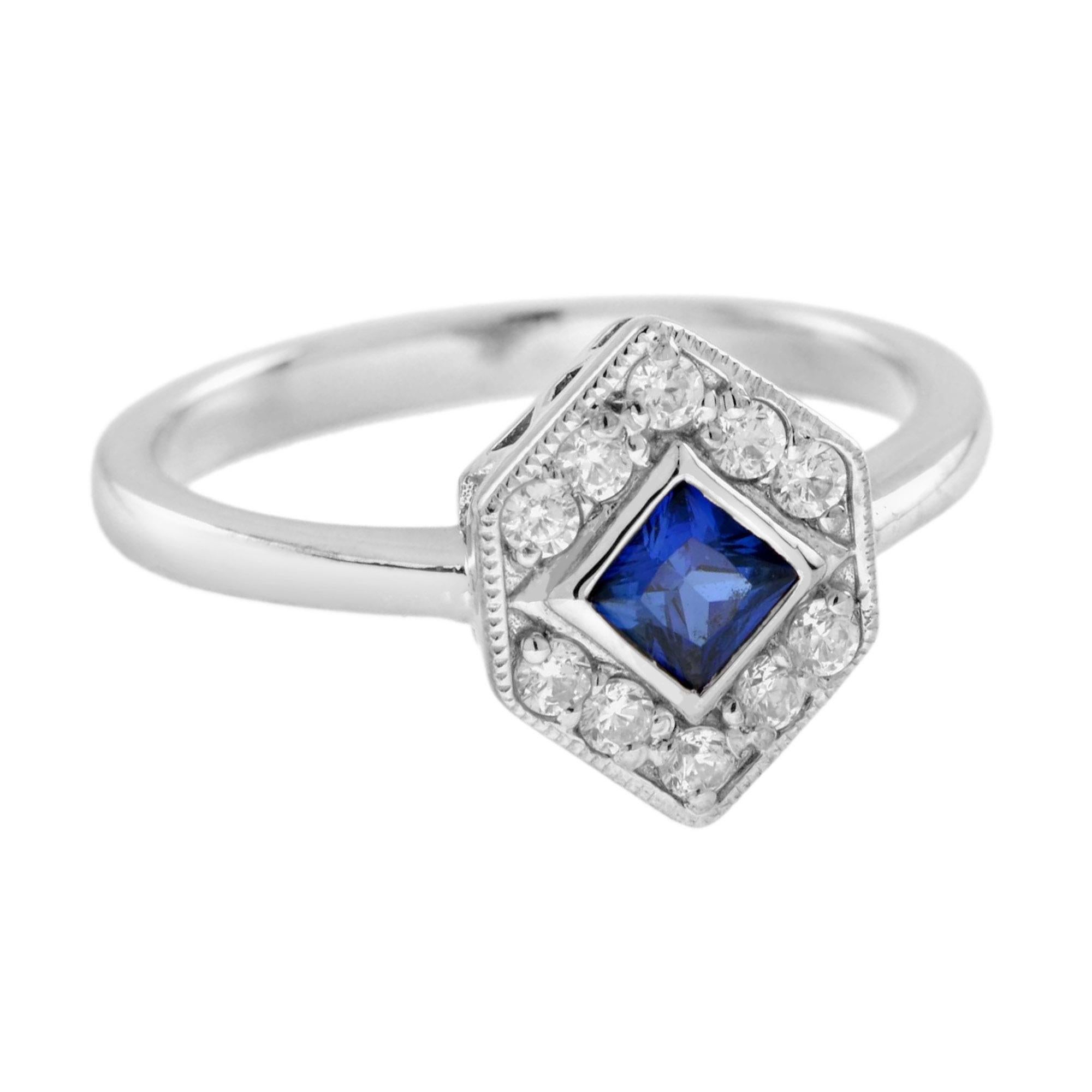 An unusual and very pretty white gold ring that bezel set with a beautiful royal blue square cut sapphire. Around the sapphire in a hexagon design are 0.19 carat diamonds. There is millgrain detail throughout that adds extra detail to this beautiful