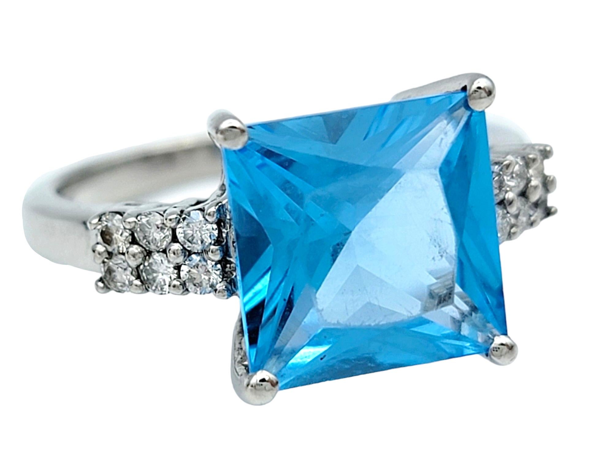Ring Size: 8

Set in radiant 14 karat white gold, this enchanting ring features a square-cut blue topaz at its center, exuding a captivating azure brilliance. Flanking the vibrant gemstone are shimmering pavé
diamonds, delicately set within