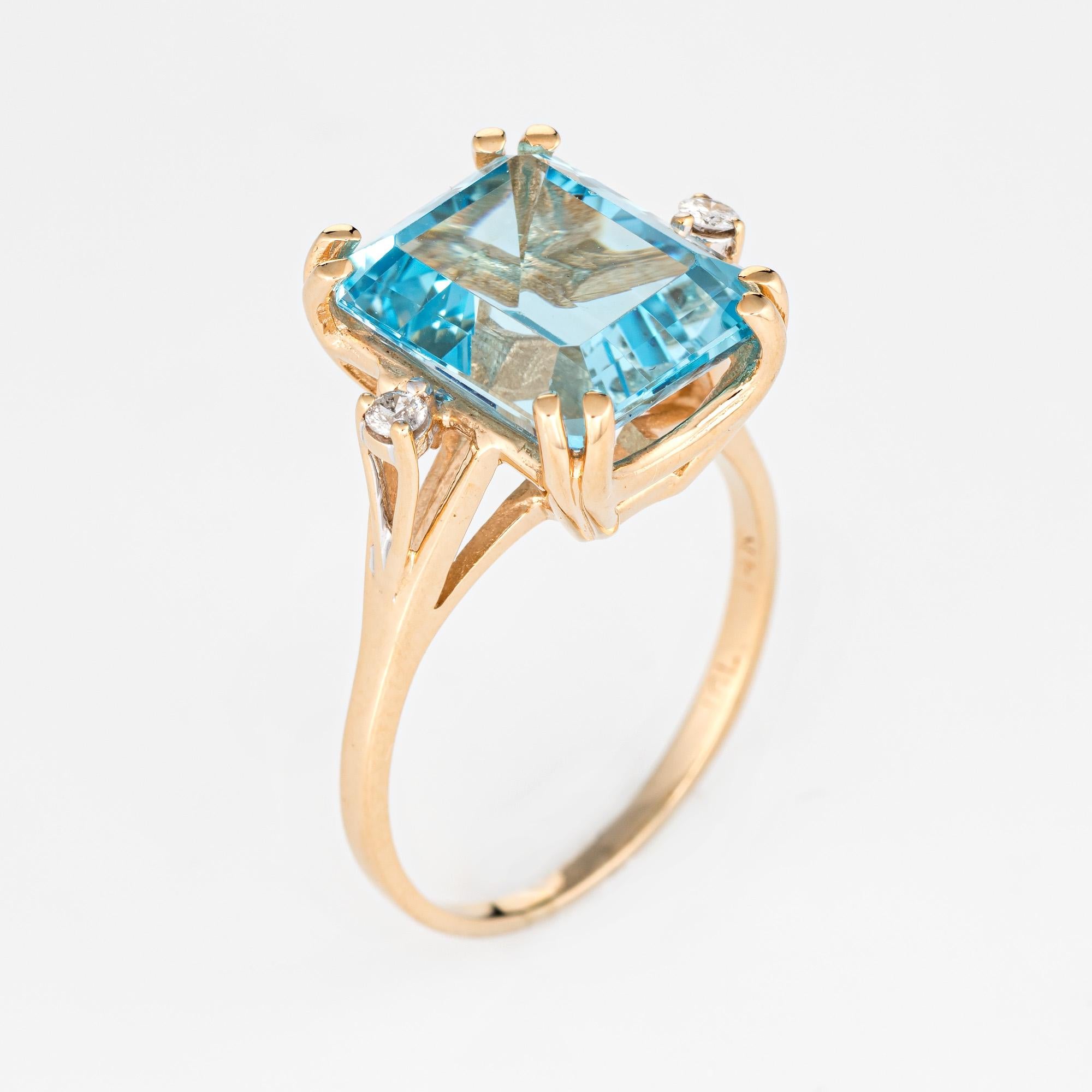 Stylish vintage blue topaz & diamond cocktail ring (circa 1980s to 1990s) crafted in 14 karat yellow gold. 

Emerald cut blue topaz measures 12mm x 10mm (estimated at 9 carats) is accented with an estimated 0.02 carats of diamonds (estimated at H-I