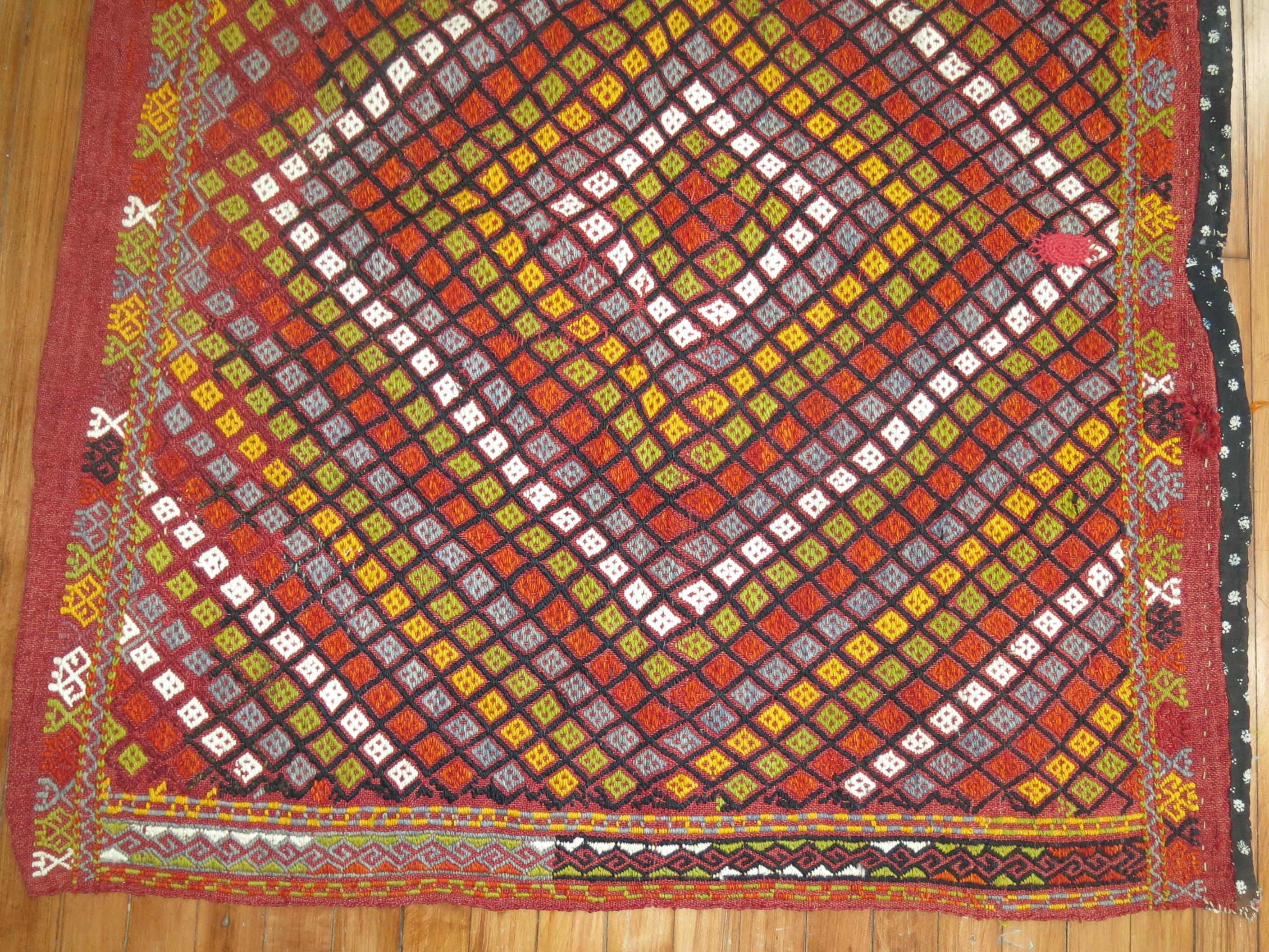 Colorful midcentury Turkish Jajim. Dominant accents in orange, yellow, green.

Measures: 3'6” x 4'2”

With the Jijim weaving technique, different colored threads are applied between the weft and warp threads, on the reverse of the weave. It is