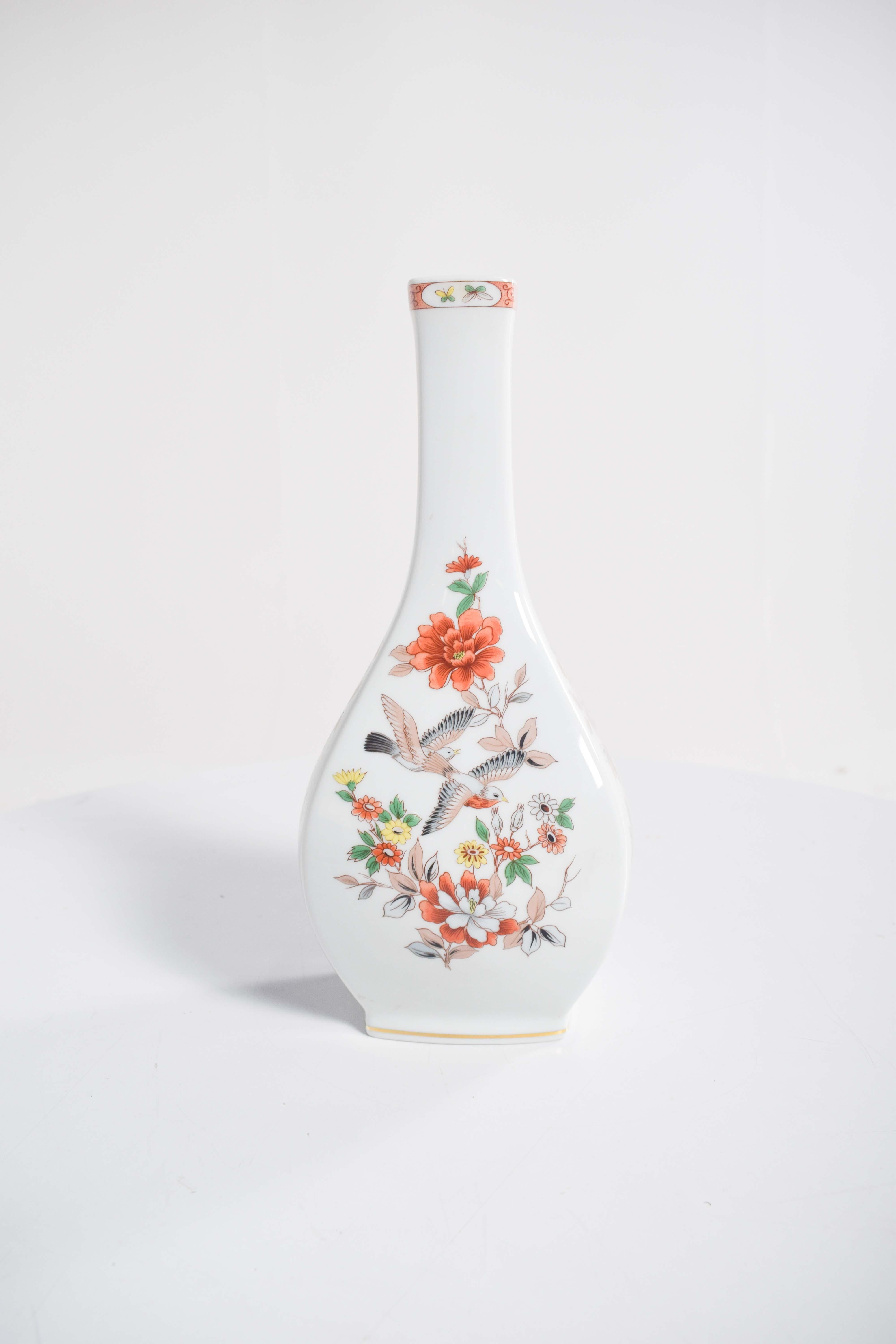 This exquisite square bottle, crafted in Vista Alegre porcelain, is a remarkable display of artistry and craftsmanship. The bottle features a sturdy, square base that provides a sense of stability and elegance. Its smooth porcelain surface is