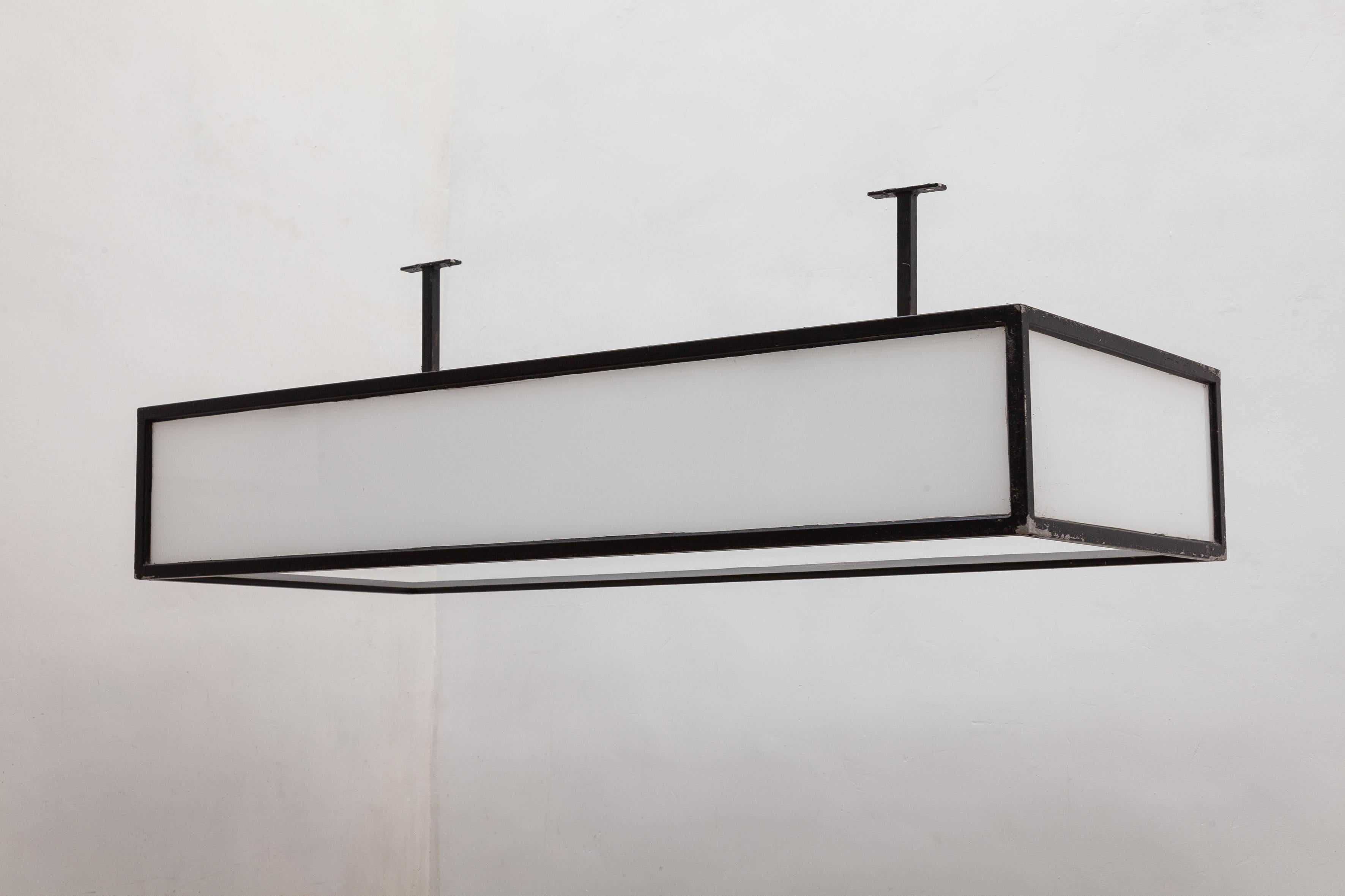 Bauhaus style large ceiling light or wall light, black and white light fixture. White opaline glass box with an iron frame. The frame has been painted black and has a vintage patina. Lit by 2 fluorescent bulbs. Three of these square box lights are