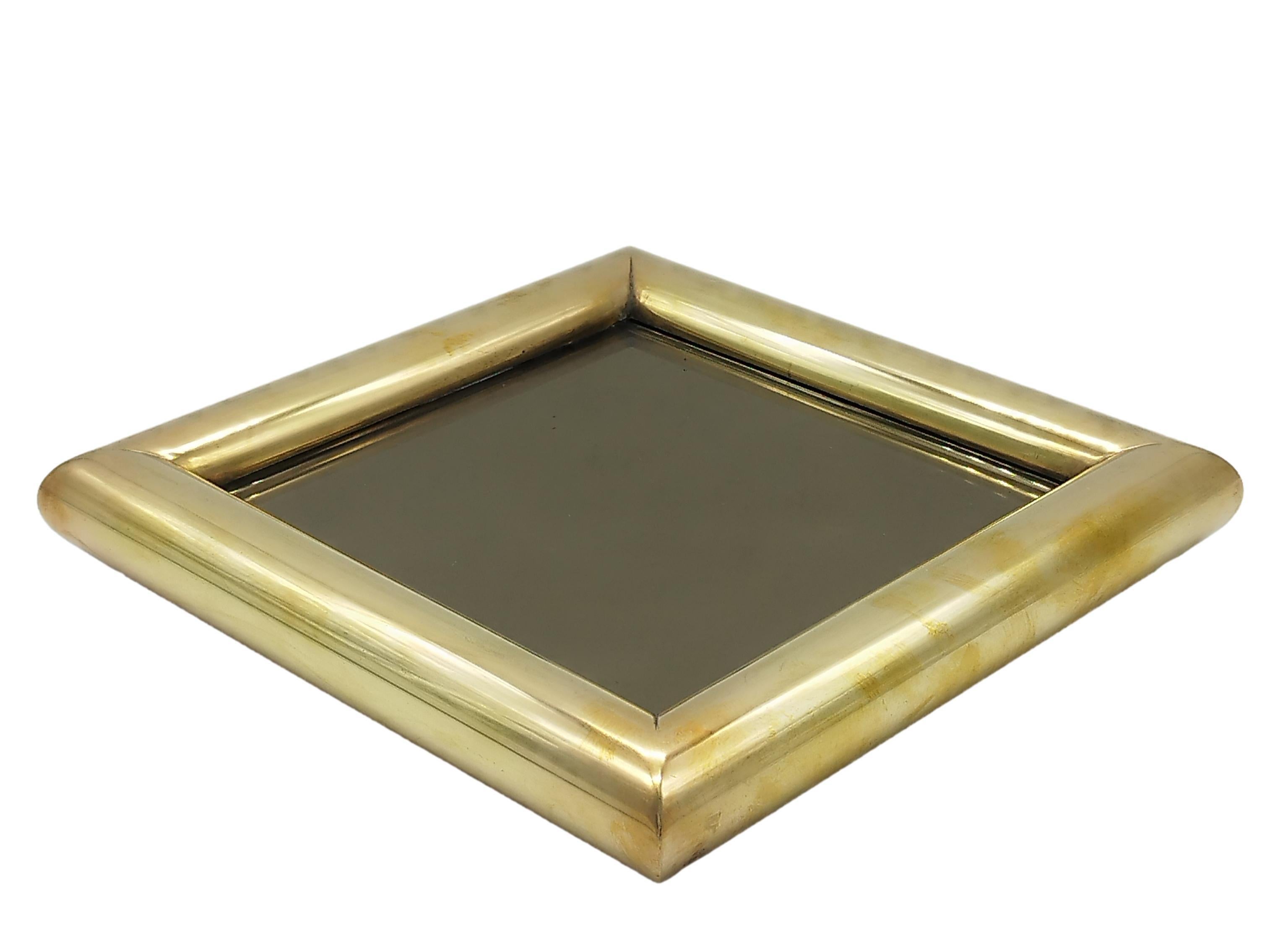 Plato cuadrado totalmente de latón macizo con cristal ahumado espejado en el interior, Muy buen estado del cristal ahumado, rigurosamente sin arañazos. Pátina en las varillas de metal dorado. Una línea sobria y soberbia.