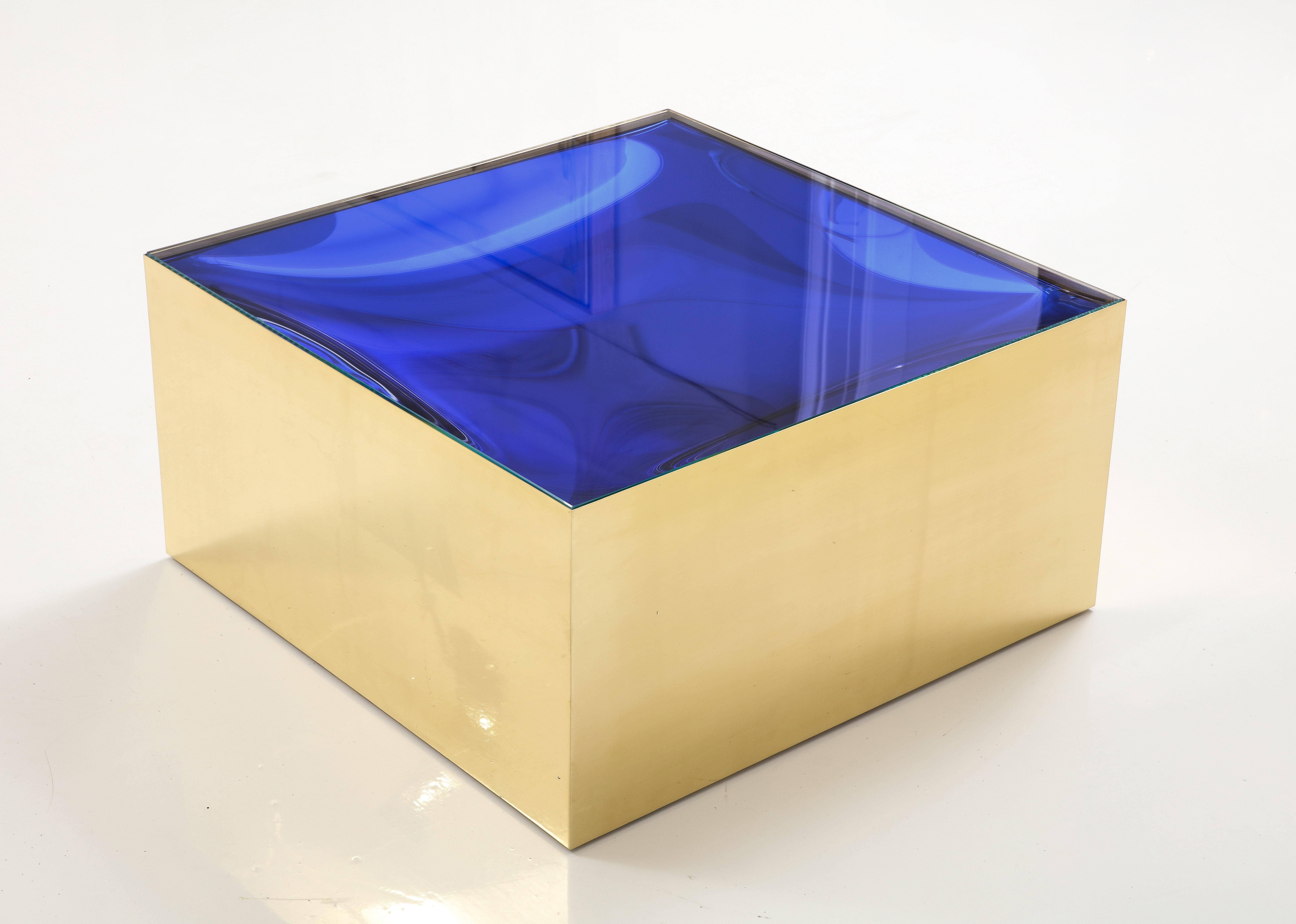 Bespoke and specially designed square brass and blue glass cocktail or coffee table inspired by Max Ingrand for Fontana Arte. This cocktail or coffee table consists of a square base in lacquered brass with 2 top glass inserts. The first (or inner