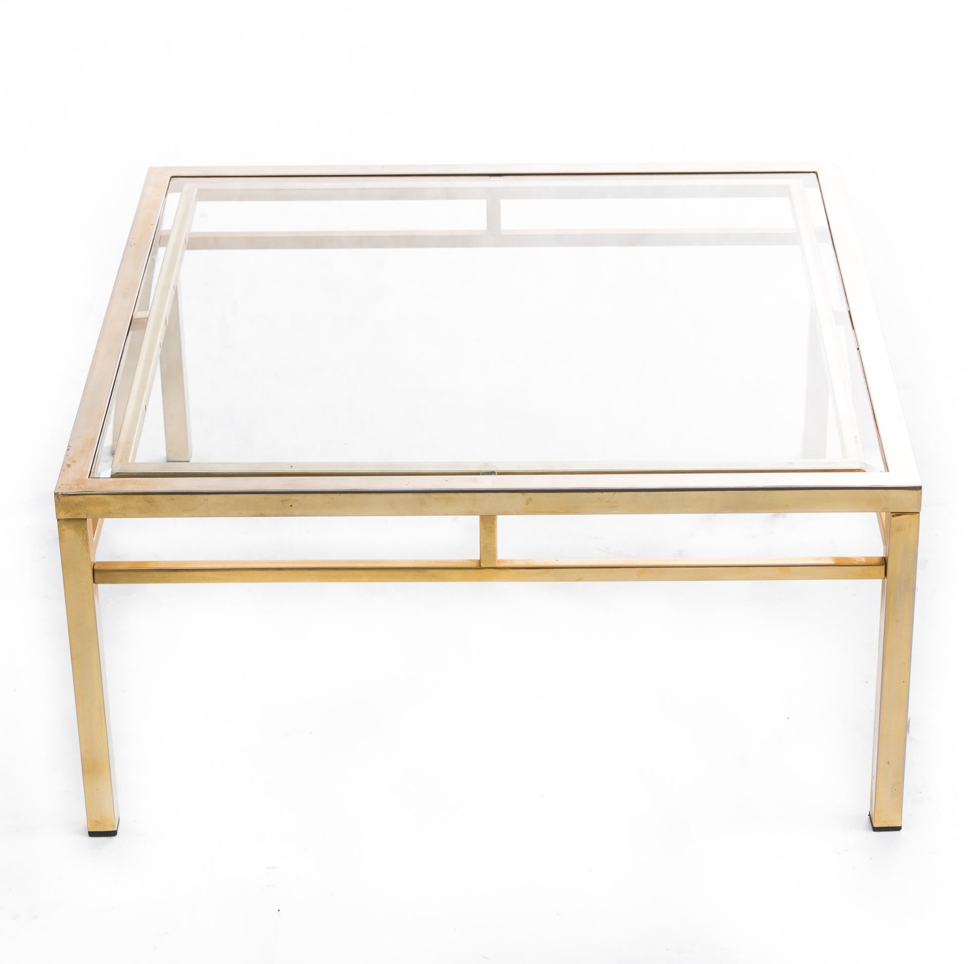 A transparent table made of polished brass and glass. A simple, noble form is emphasized by the highest quality materials. Construction is made of solid brass profiles.