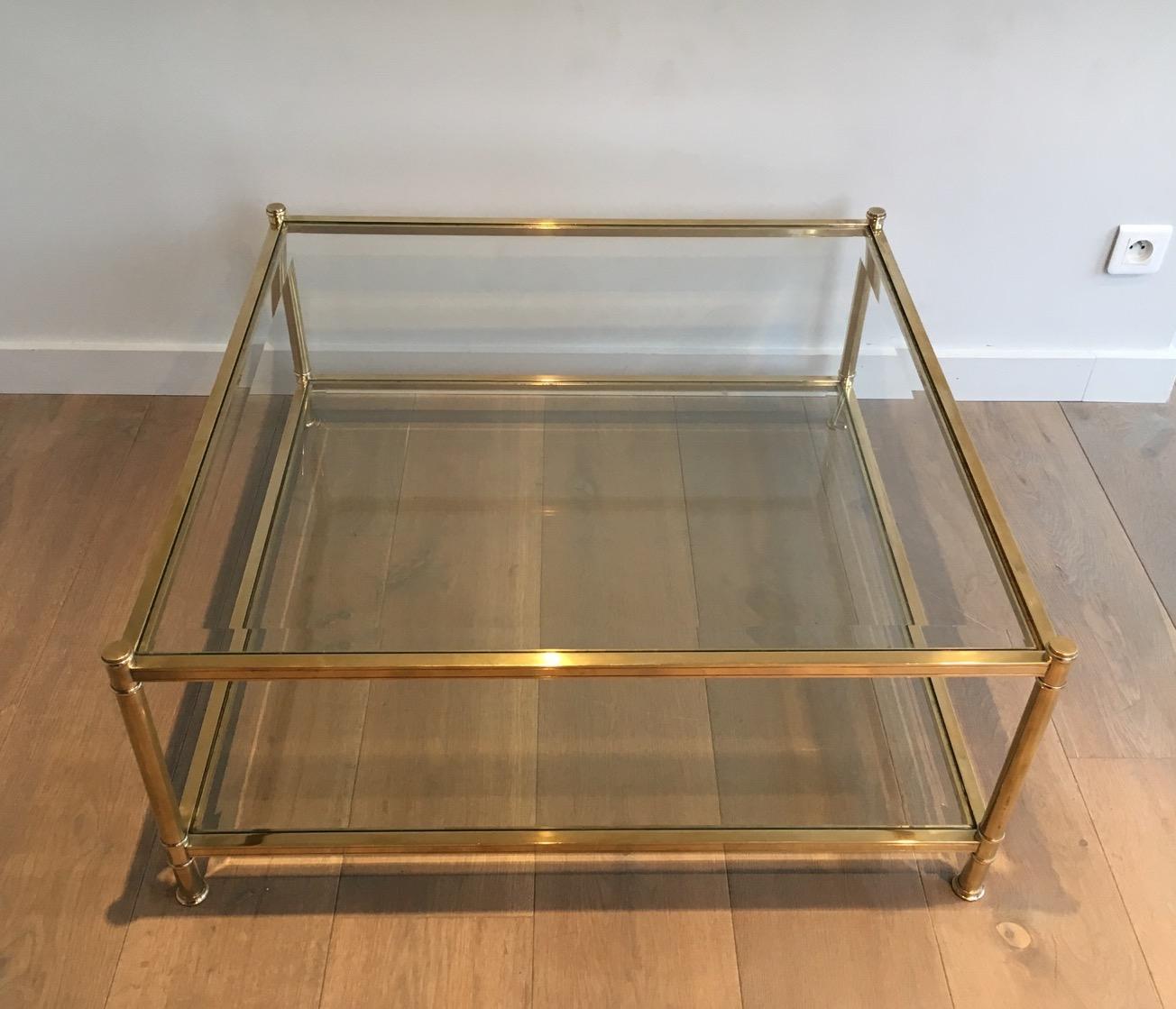 This very elegant square coffee table is all made of brass with glass shelves. The quality is really good. This is a French work, circa 1970.