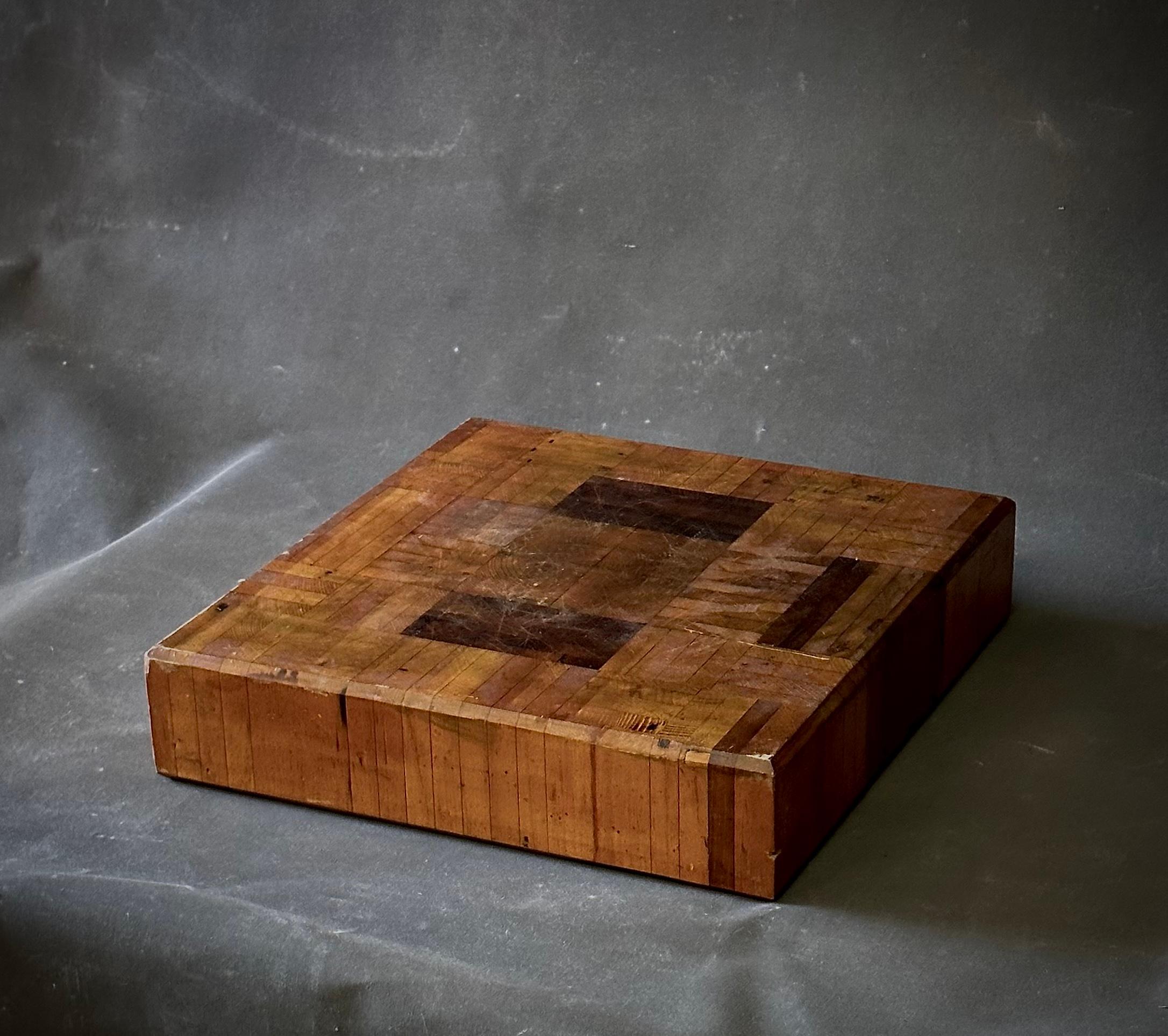 Early 20th century, French butcher block. The warm tones of wood and parquet-style surface make this an interesting tabletop accent or serving platter. 

France, circa 1890.

Dimensions: 17.5 W x 17 D x 4 H.