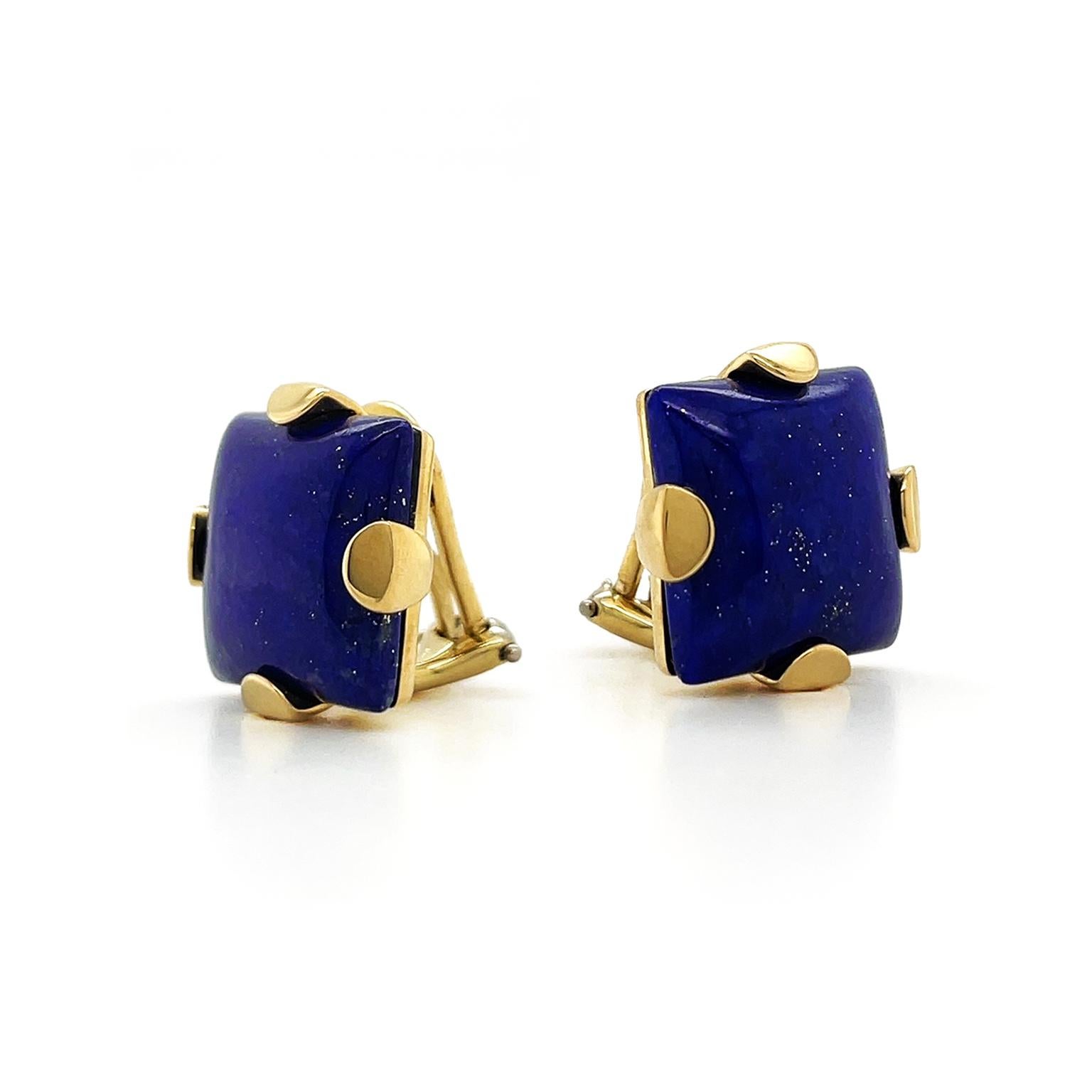 The profound tone of the Lapis lazuli is elevated by being carved into a square cabochon. 18k yellow gold prongs secure the gem, while also heightening its shimmery gold flecks. The total weight of the lapis lazuli is 21.28 carats. Clip-backs