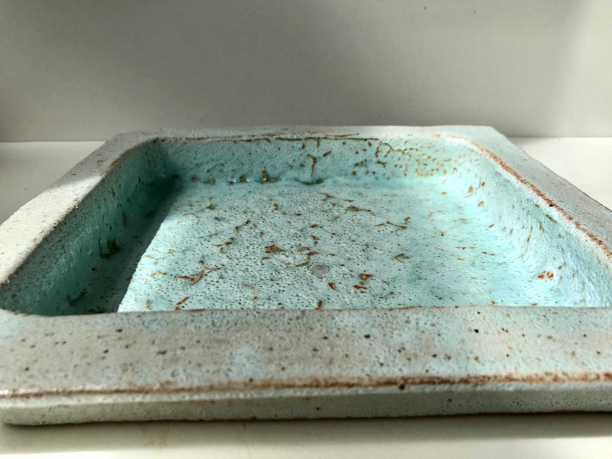 A studio piece unique in fire burnt stoneware. Its features a minty 'soap' glaze and a strict square shape. Designed by Sten Børsting at made at his Studio in Ribe, Denmark.
 