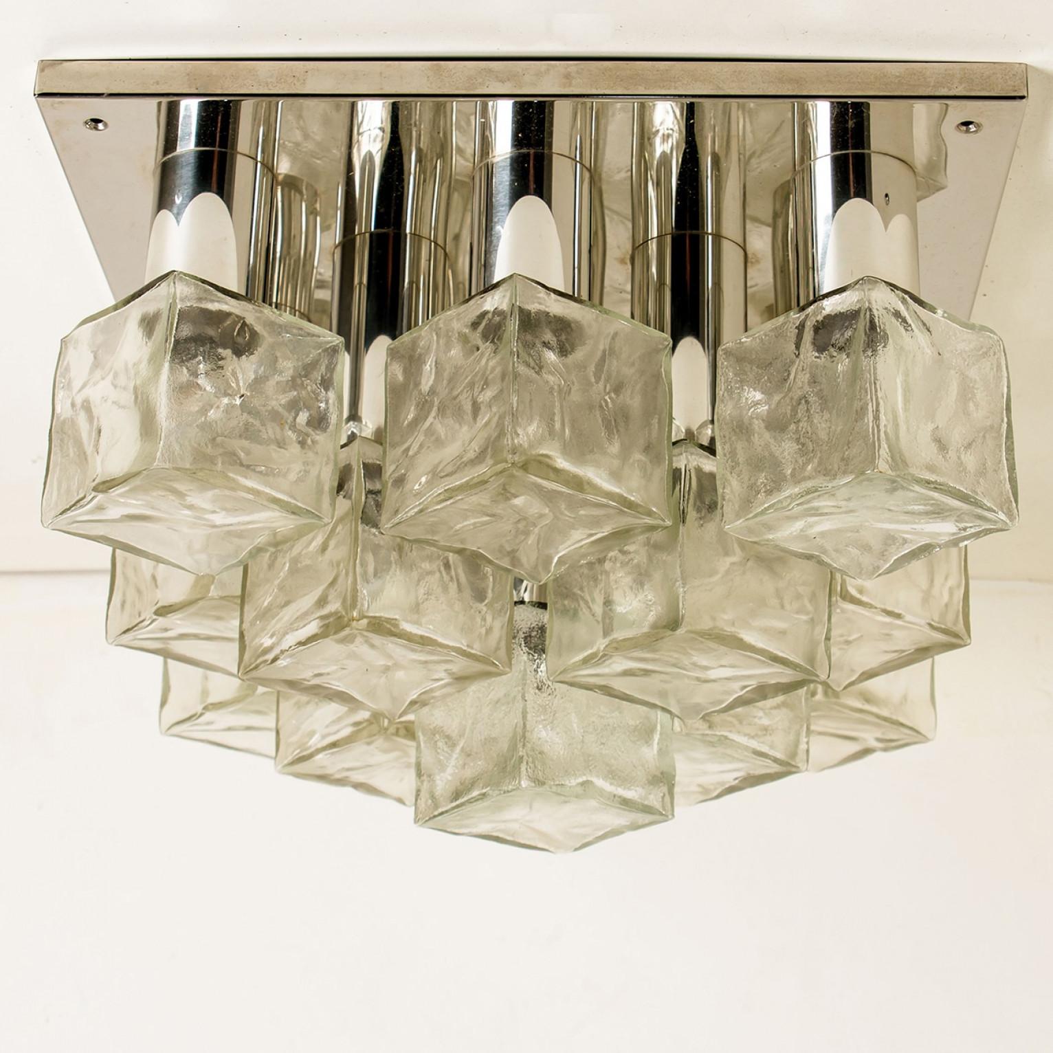 Kalmar flush mount light, chrome, cast ice glass, ca. 1970 There are 13 small base Edison bulbs up to 40W per bulb which are covered with textured ice glass cubes.
Illuminates lovely due to the wonderful textured square glass tubes.

In very good