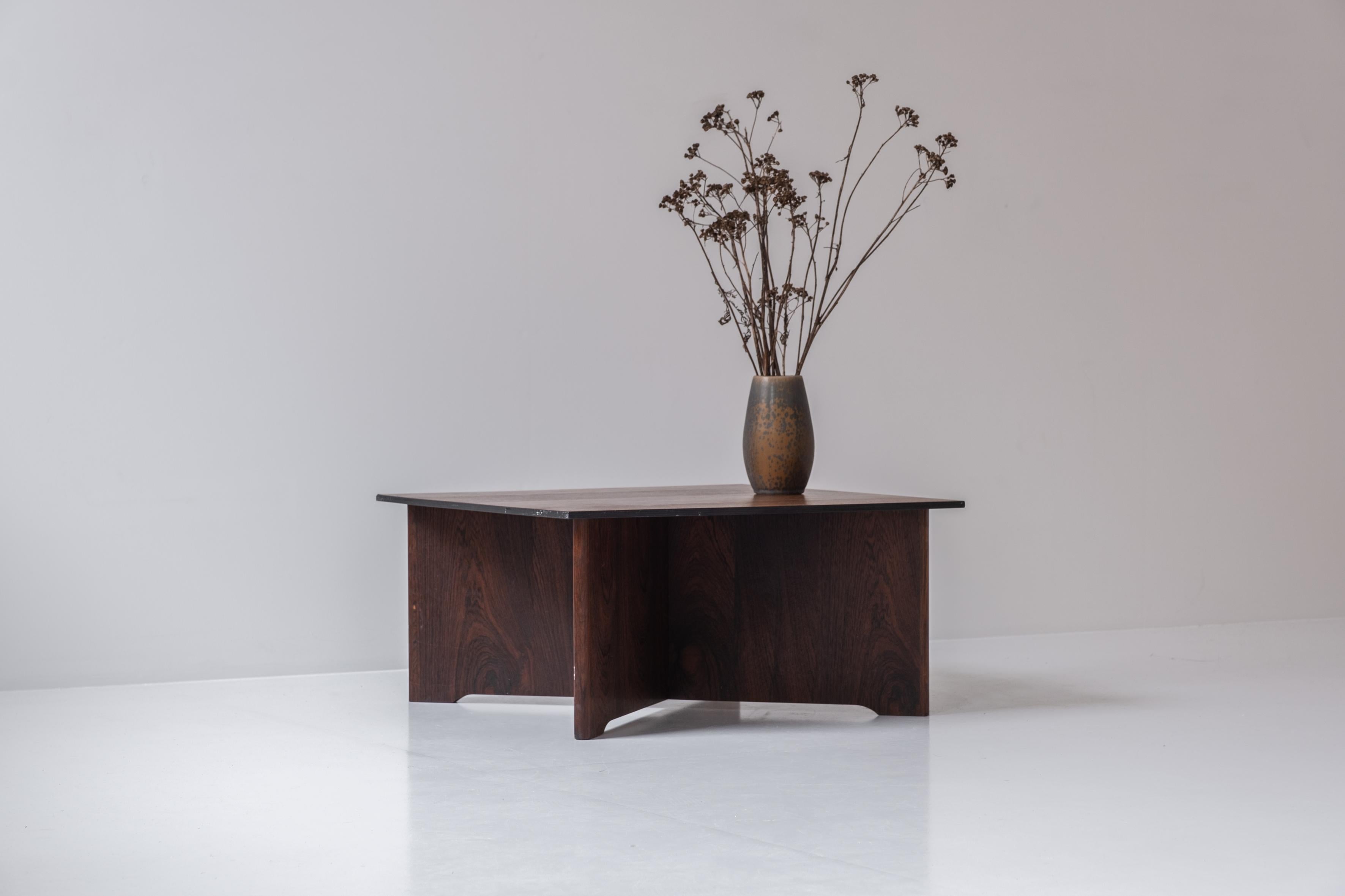 Square coffee table from Denmark, designed in the 1960s. This low coffee table or side table features a base and top of rosewood. Atypical size. Gorgeous grain.