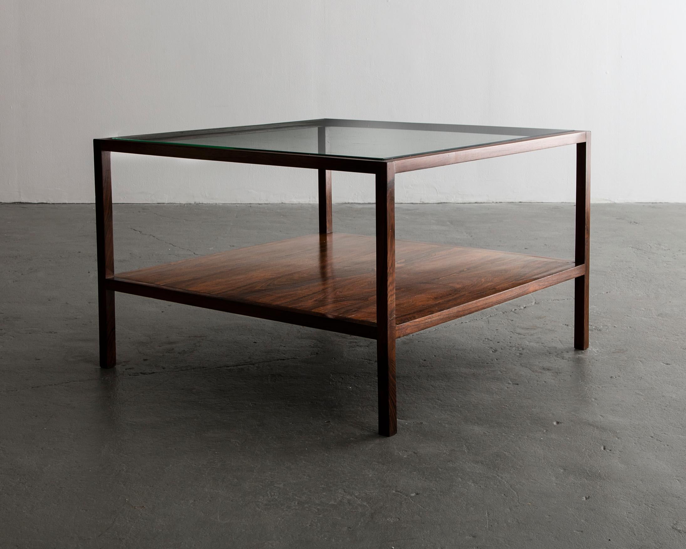 Square coffee table in jacaranda with glass top and shelf underneath. Designed by Joaquim Tenreiro, Brazil, 1954.