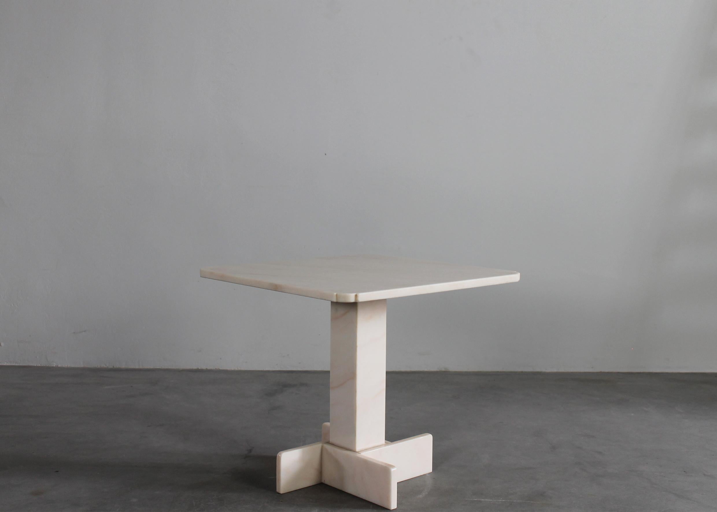 Square-shaped coffee table entirely made with pink marble. 
