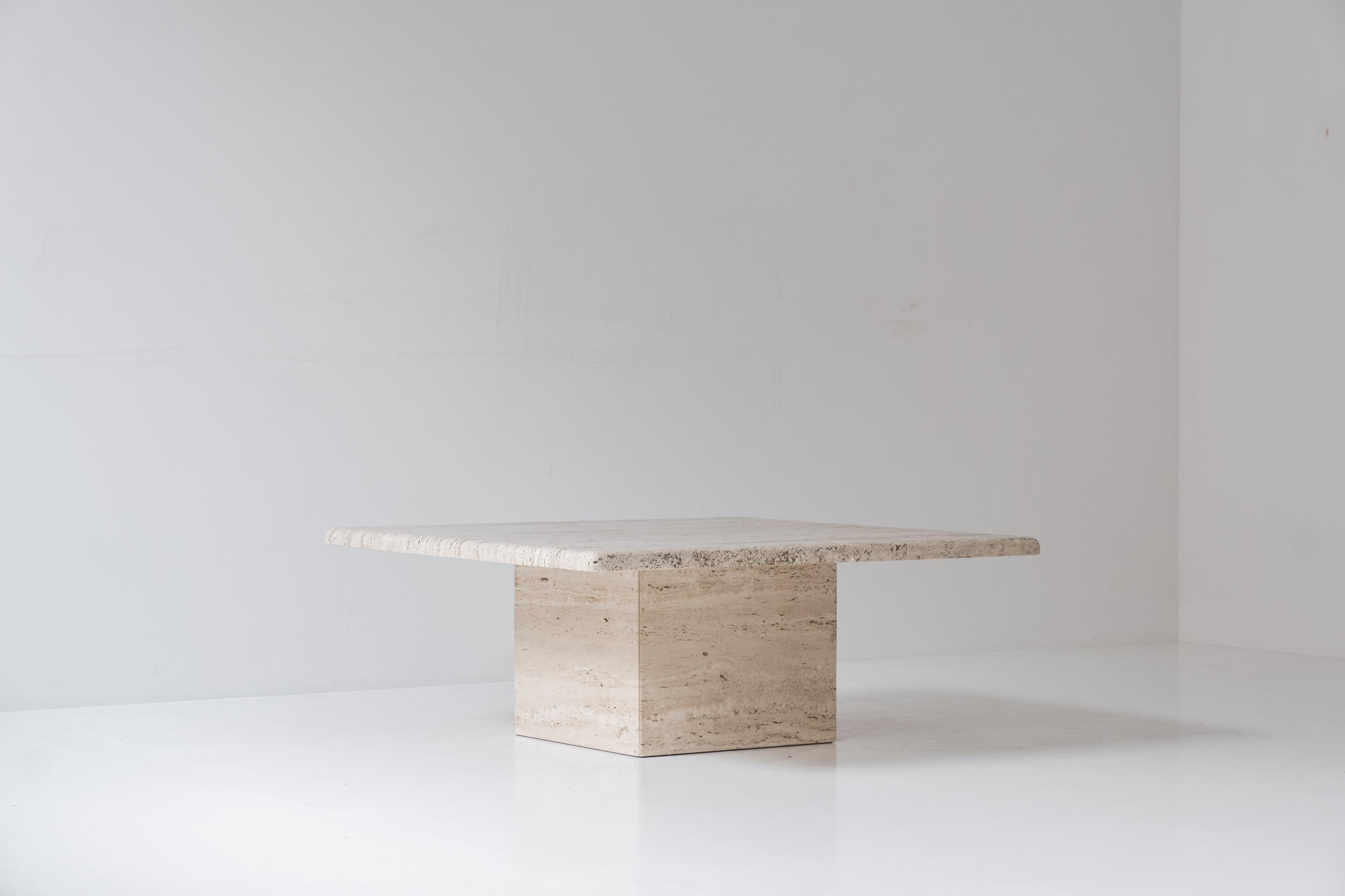 Square coffee table from the 1970’s. The table is fully made out of travertine with variegated tones of beige and brown. The top rests on a unique cylinder pedestal base. Presented in a beautiful and original condition with only minor wear.