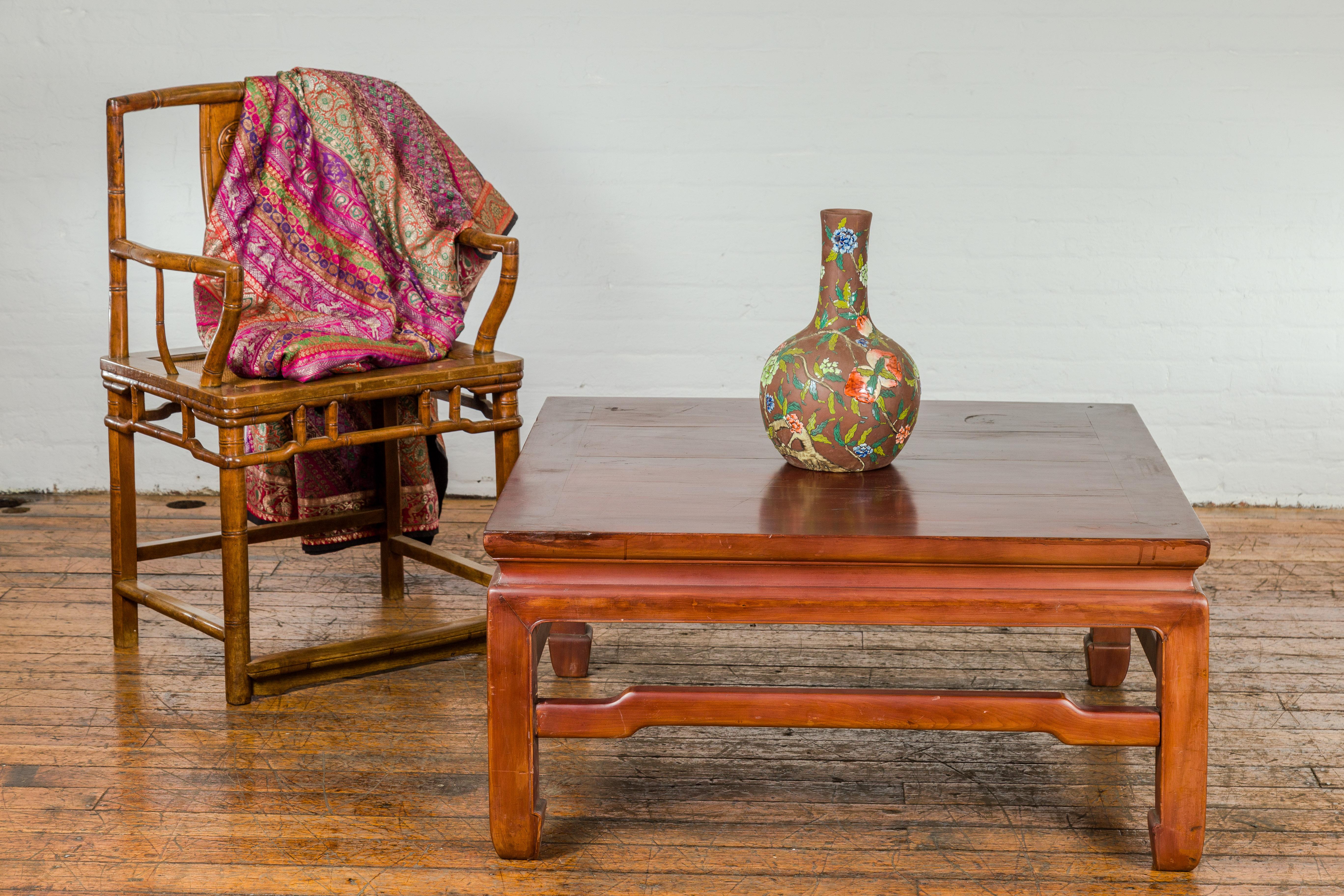 A late Qing Dynasty period square shaped coffee table from the early 20th century with humpback stretchers and horse hoof legs. This late Qing Dynasty period coffee table, dating from the early 20th century, is a remarkable artifact that beautifully