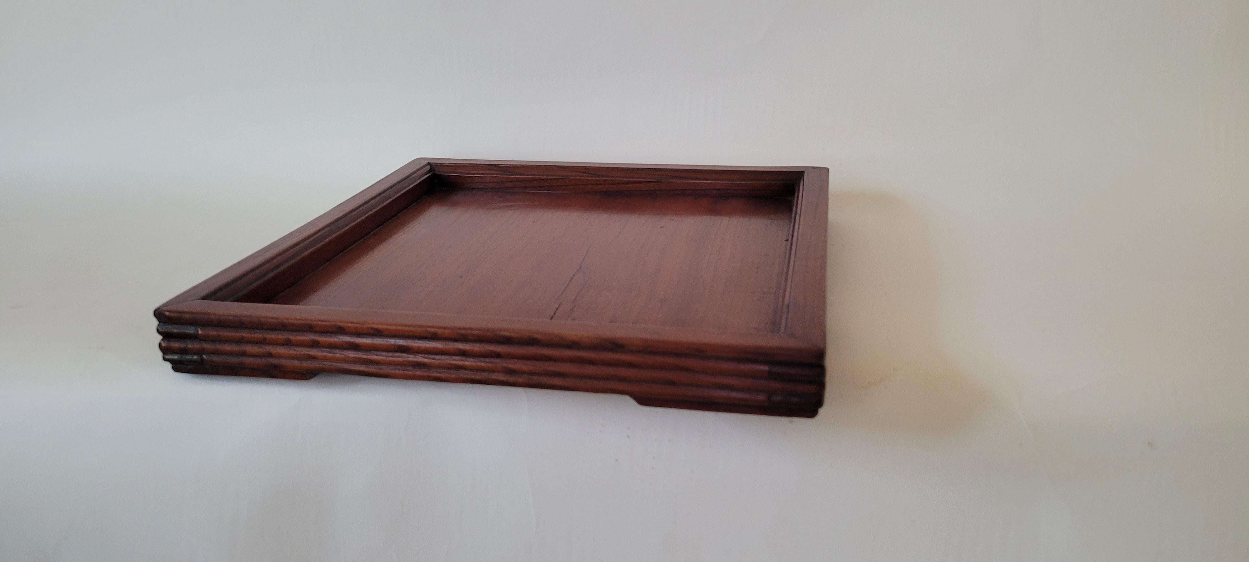 Tray
This is a square tea tray with beveled frame members and corner small base.

Material:	Jumu (Southern Elm)
Size:		1.5h x 12.75w x 12.75d
Origin:		Zhejiang
Age:		Late 19th Century
