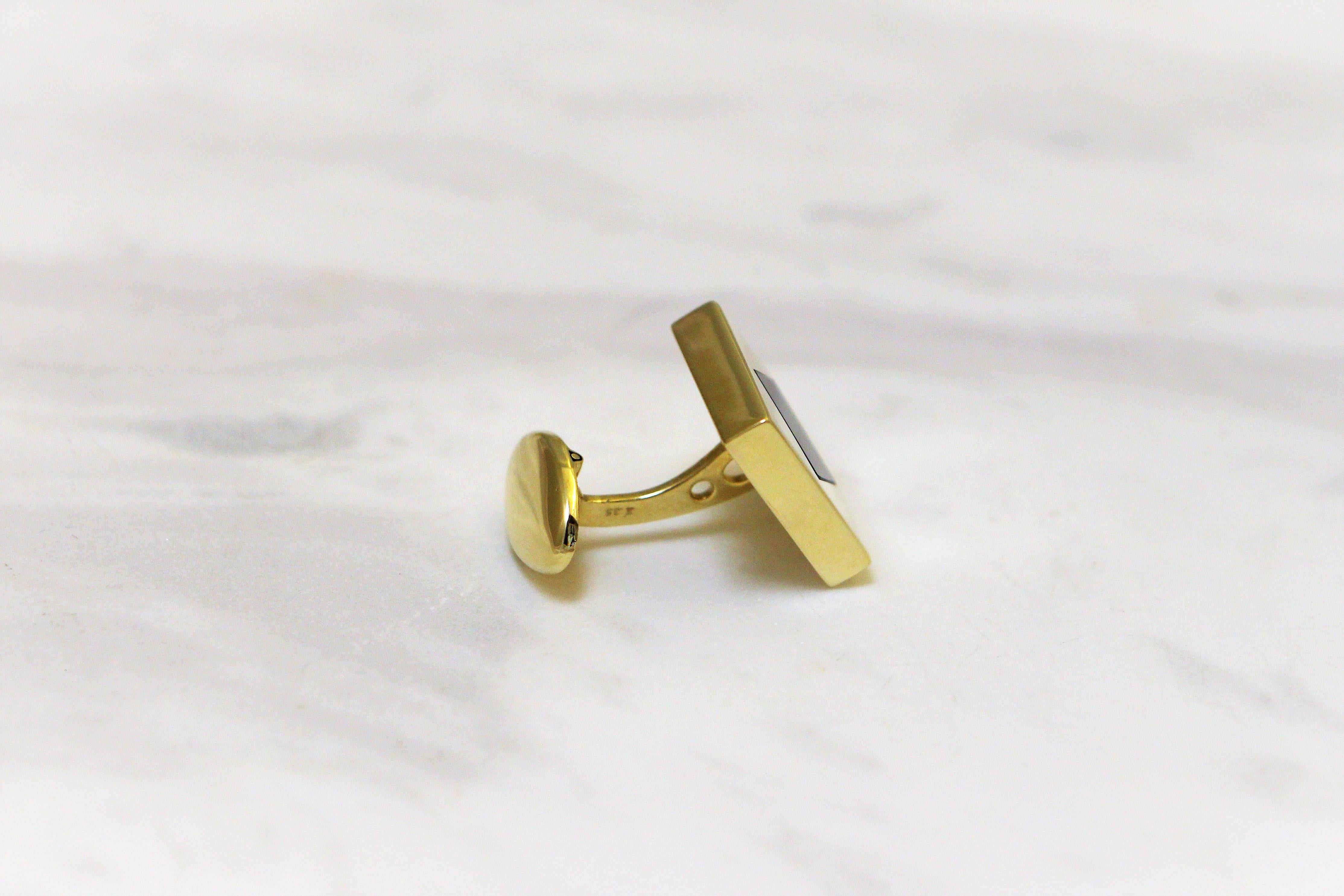 Square cufflinks handcrafted in 14Kt yellow gold featuring a rhombus black onyx centre. The black and gold colour combination captures the eternal spirit of fashion with timeless sophistication. These cufflinks belong to Metalloplasies Collection: