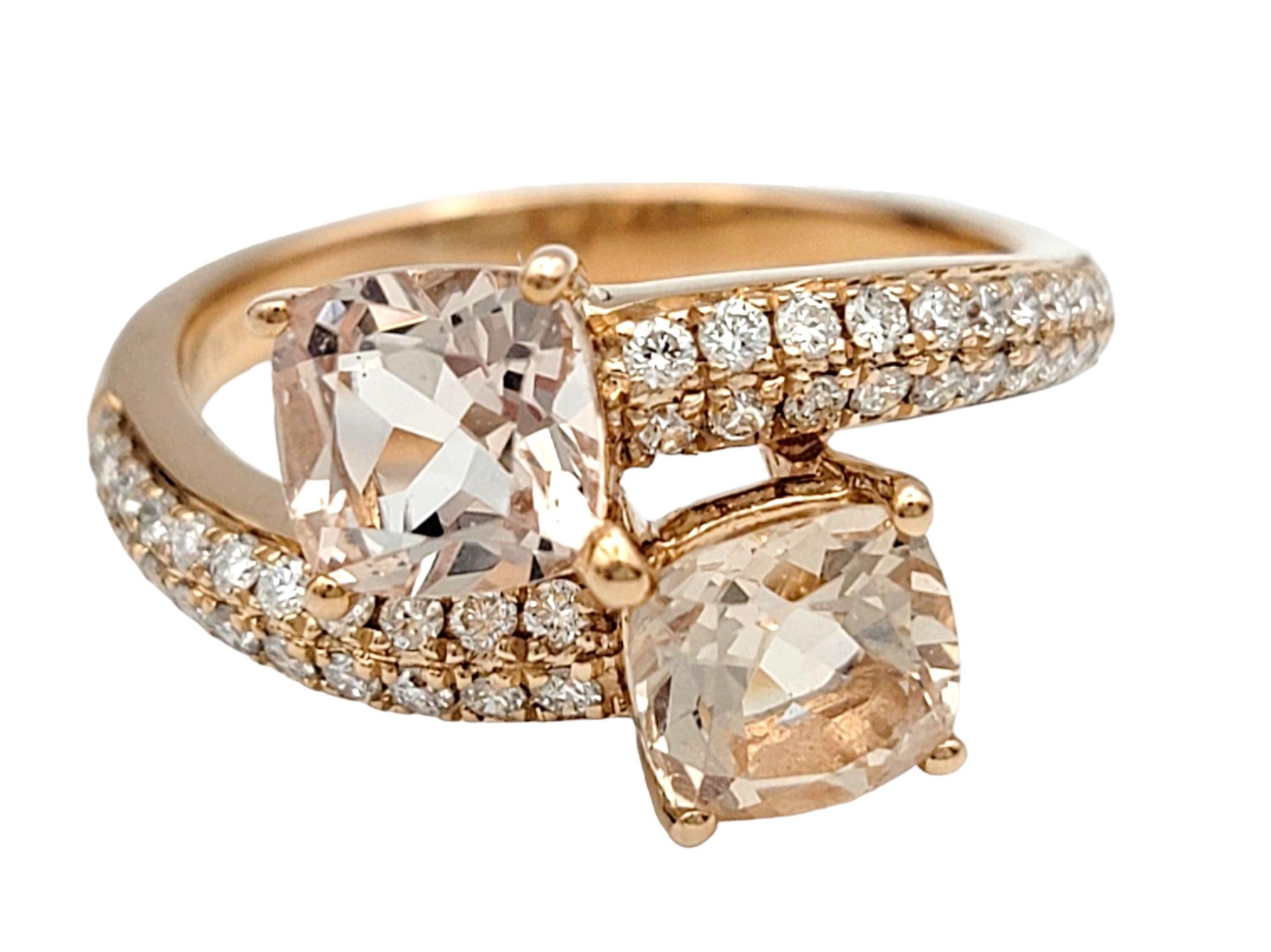 Ring Size: 6.75

This stunning morganite and diamond bypass ring set in 14 karat rose gold presents a captivating display of elegance and sophistication. At the heart of the design, two larger cushion-cut morganite gemstones command attention with