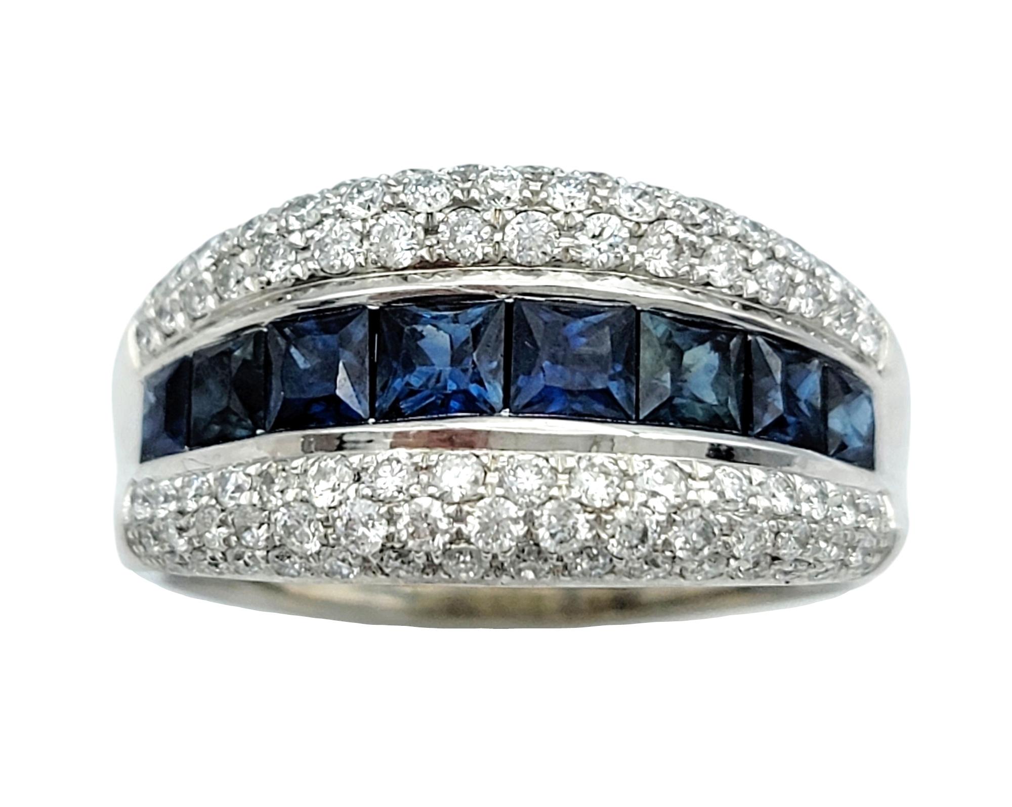 Ring Size: 7.75

Make a bold statement with this striking 14 karat white gold band ring, a luxurious combination of timeless elegance and modern design. At the heart of this captivating piece lies a row of vivid blue sapphires, their deep hues